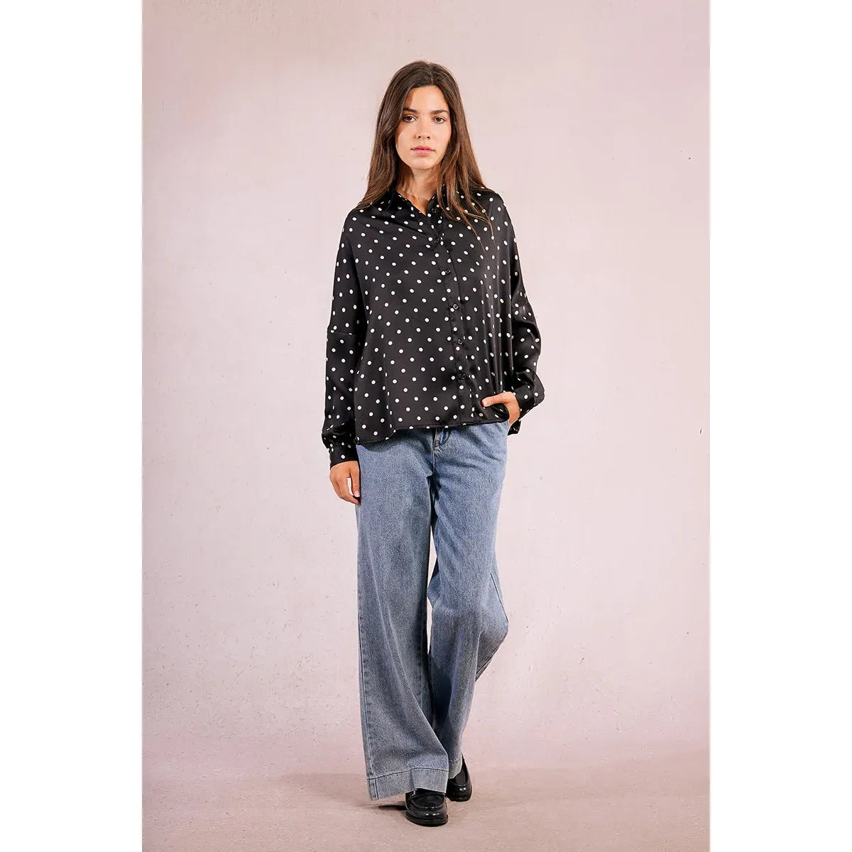 Molly Bracken Polka Dot Blouse on model, black with white polka dots, long sleeves with buttoned cuffs.