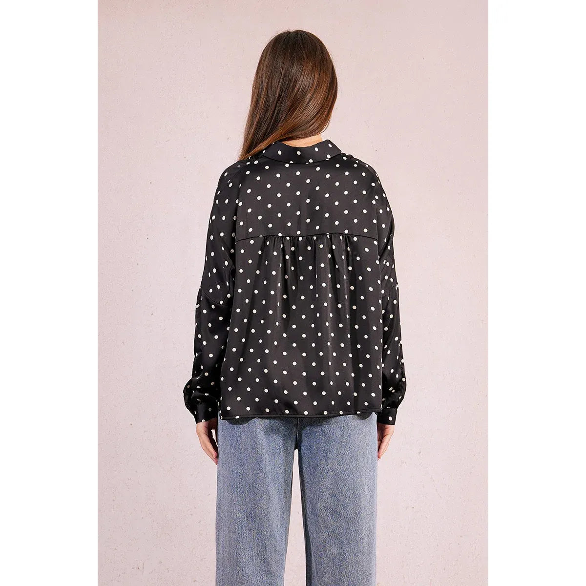 Back view of Molly Bracken Polka Dot Blouse with white polka dots, long sleeves with buttoned cuffs, gathered yoke.