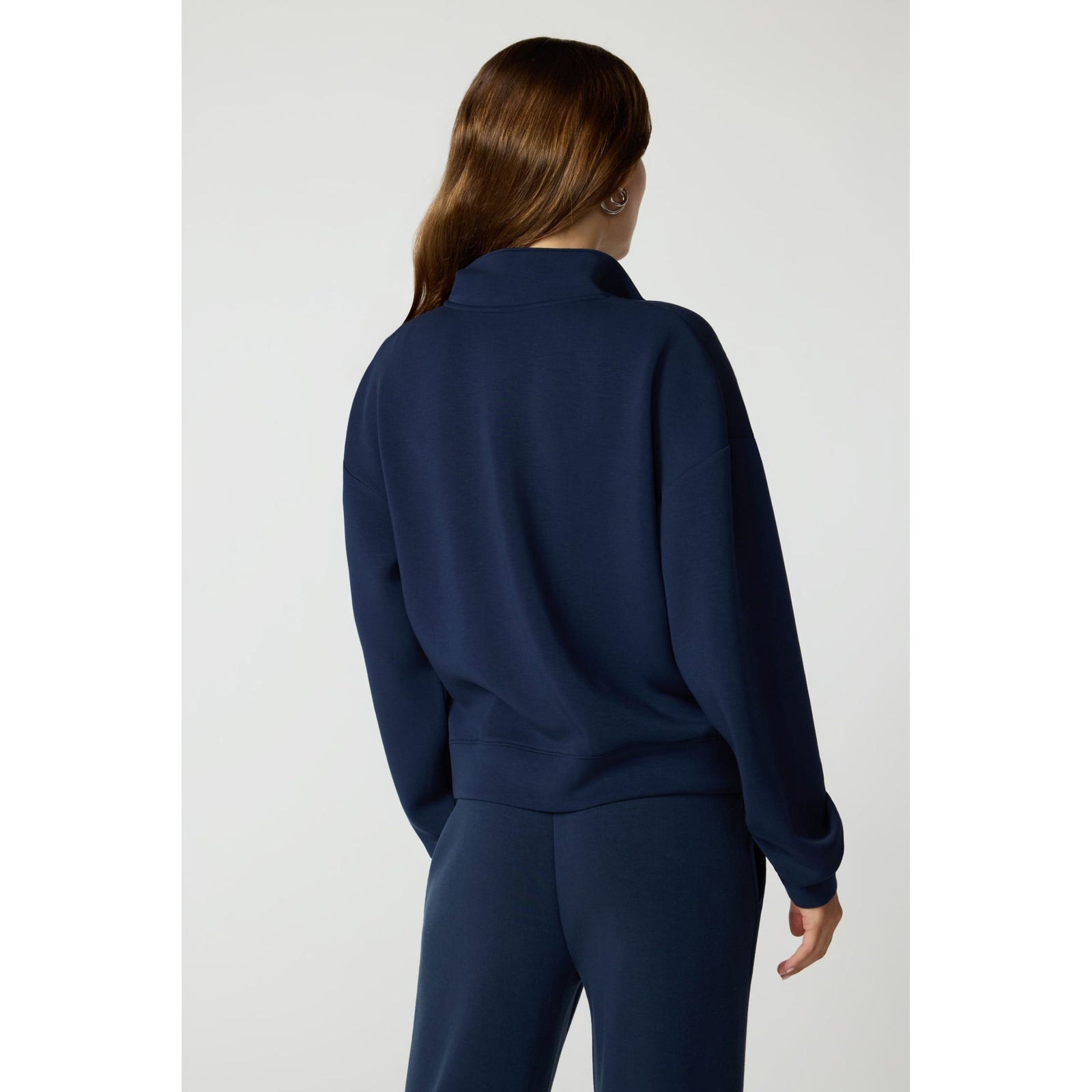 Back view of navy MPG Dreamweave crossover pullover with dropped shoulders and quarter-zip collar.
