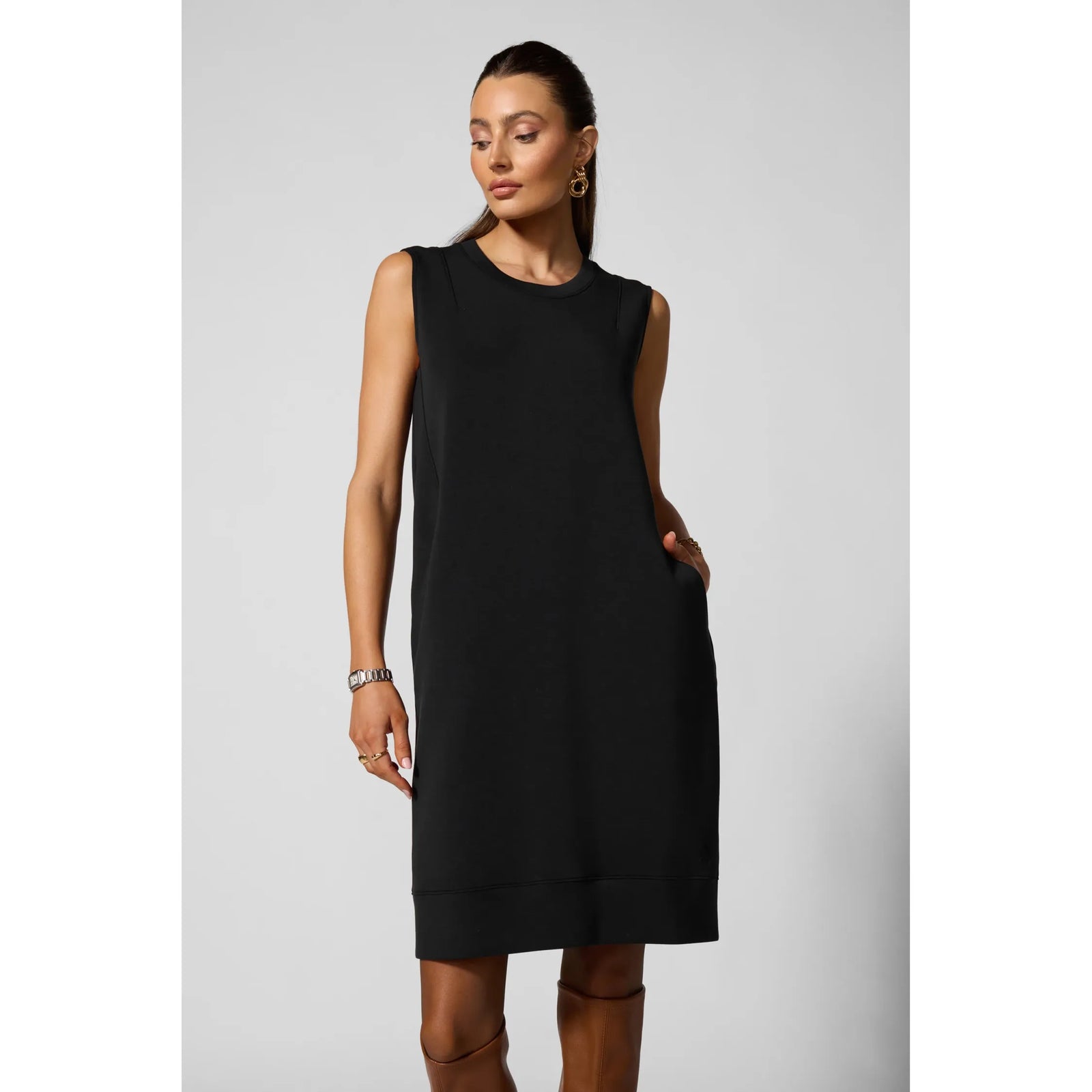 Black sleeveless dress with insert pockets and structured fit, blending casual luxury with modern tailored elements for everyday wearability.