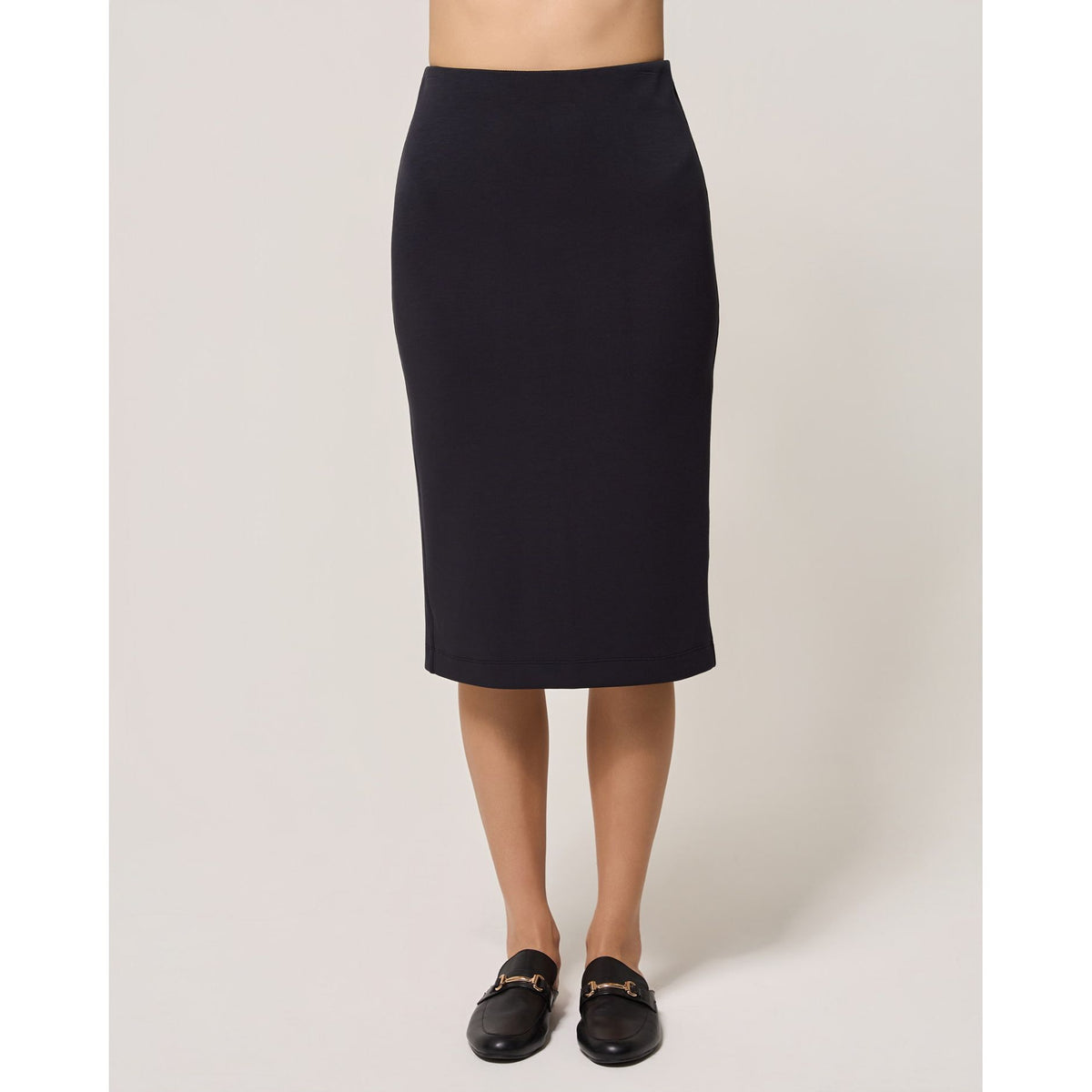 Black elastic waist pencil skirt offering a sleek fitted silhouette and comfortable pull-on midi style for an elevated everyday wardrobe.