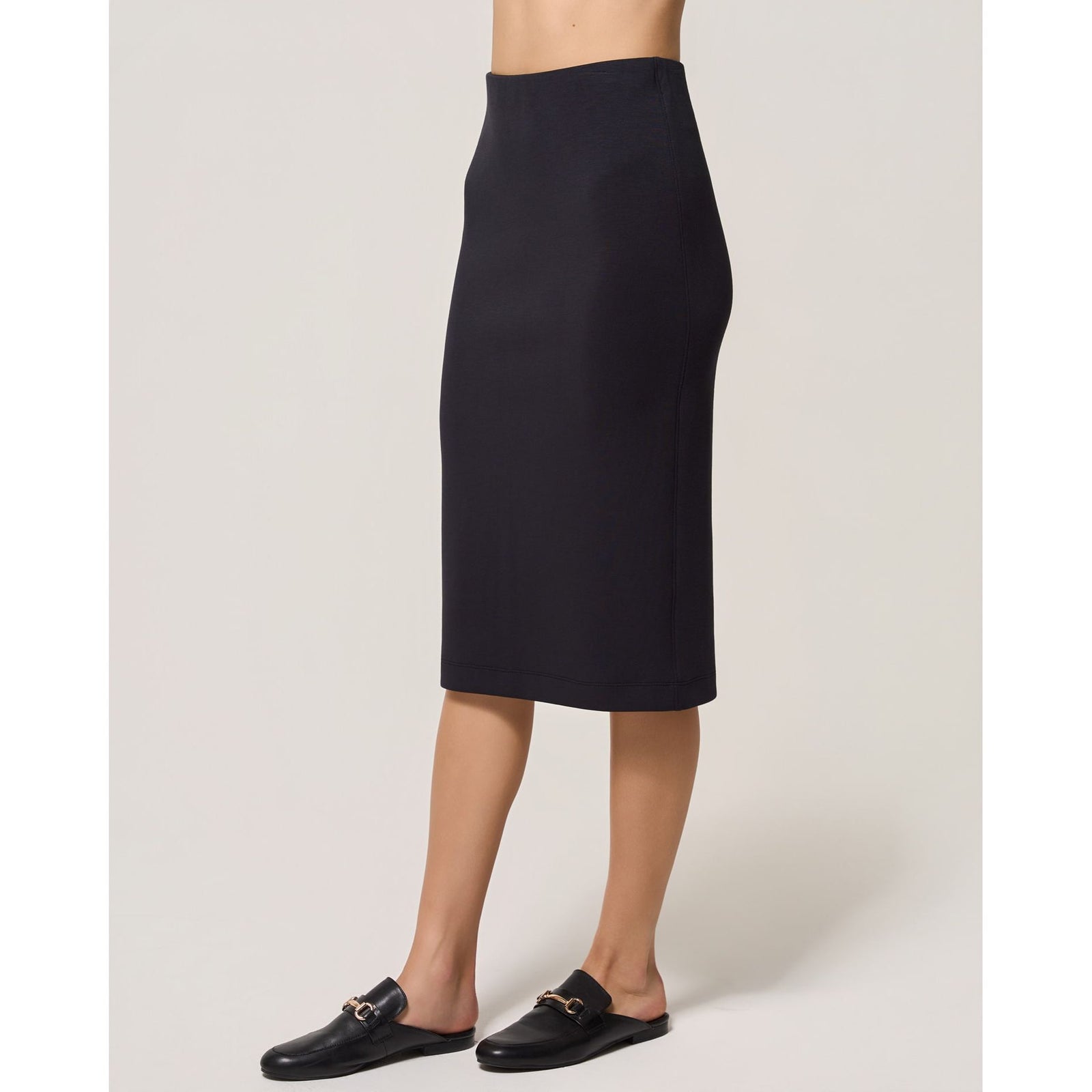 Dark navy Dreamweave pencil skirt featuring a fitted midi silhouette, elasticized waist, and back slit for comfort.