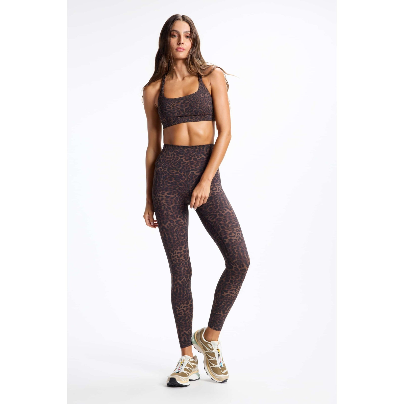 Leopard print strappy sports bra with square neckline and matching high-waist leggings for a stylish workout look.