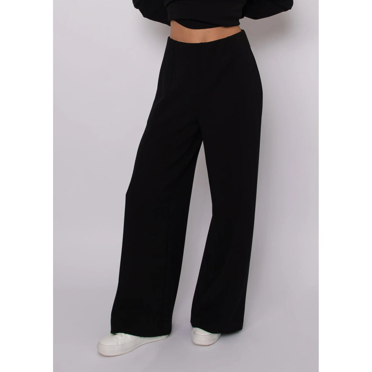 Black high-waisted soft knit pull-on pants with a relaxed drape, self-tie waist, and ankle length for an elevated silhouette.