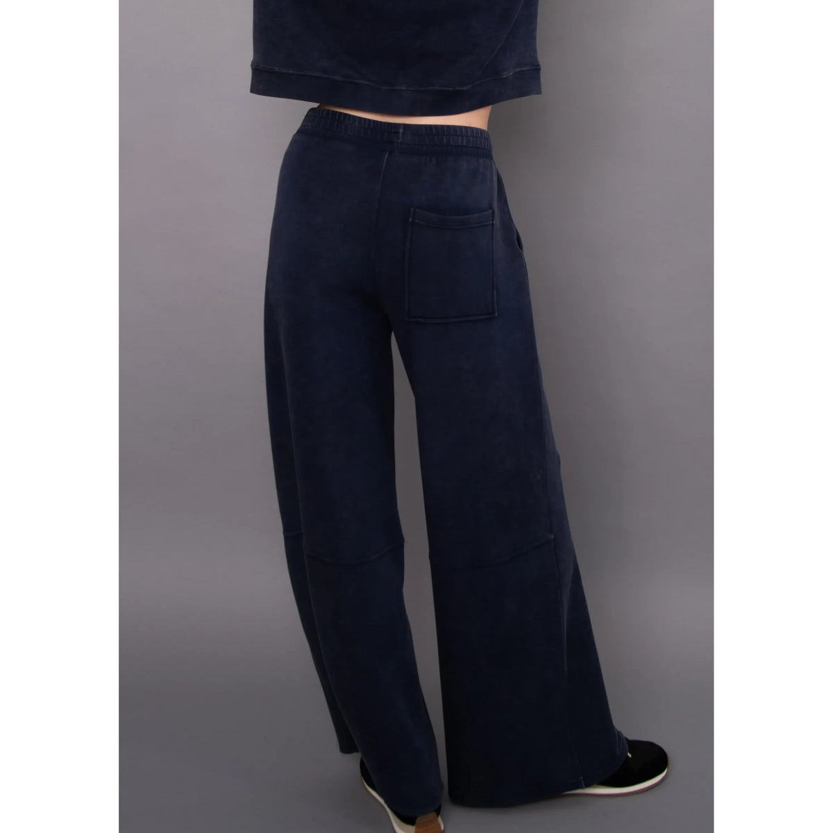 Back view of navy mineral wash soft knit pull-on pants featuring a relaxed wide-leg fit, elastic waistband, and rectangular back pocket.