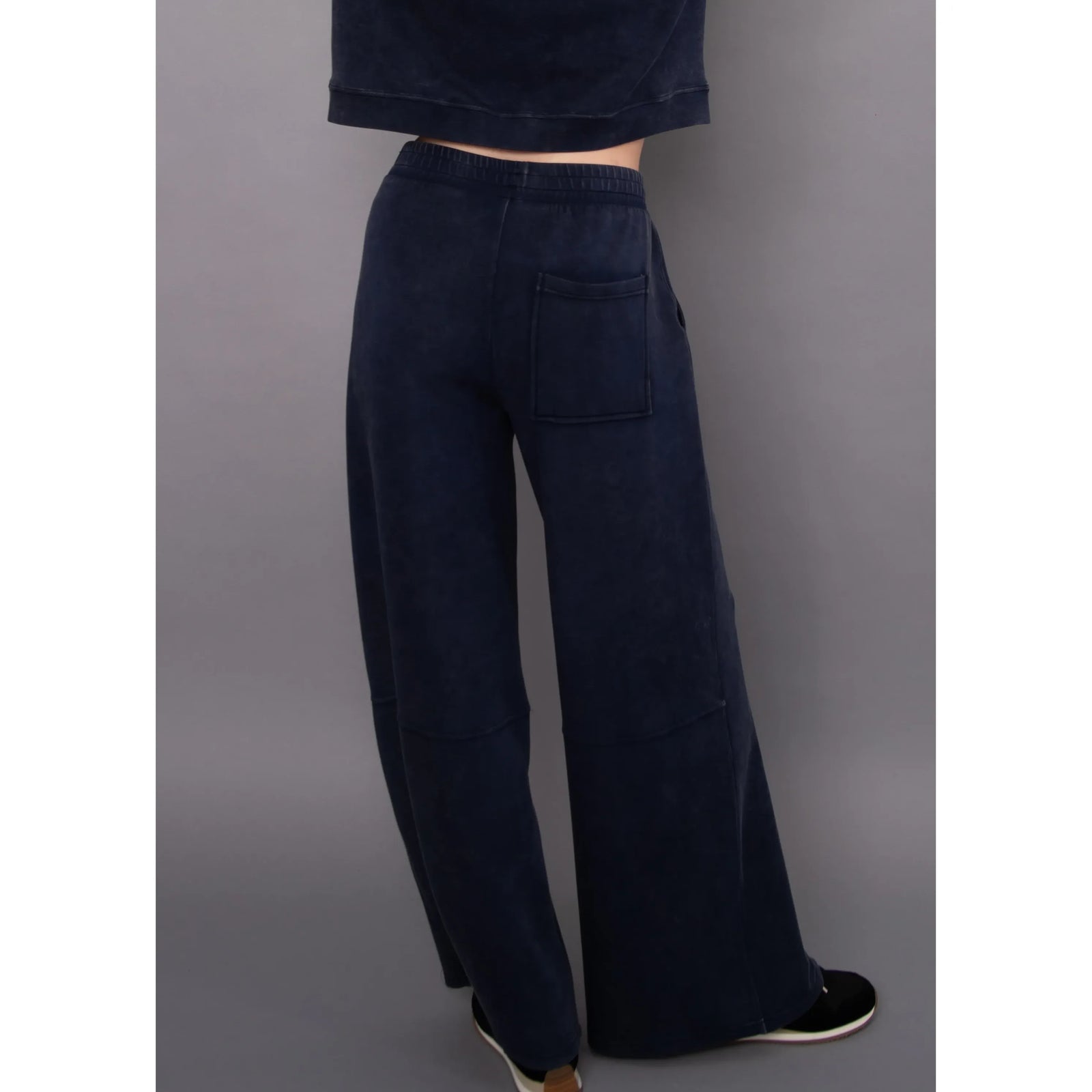 Back view of navy mineral wash soft knit pull-on pants featuring a relaxed wide-leg fit, elastic waistband, and rectangular back pocket.