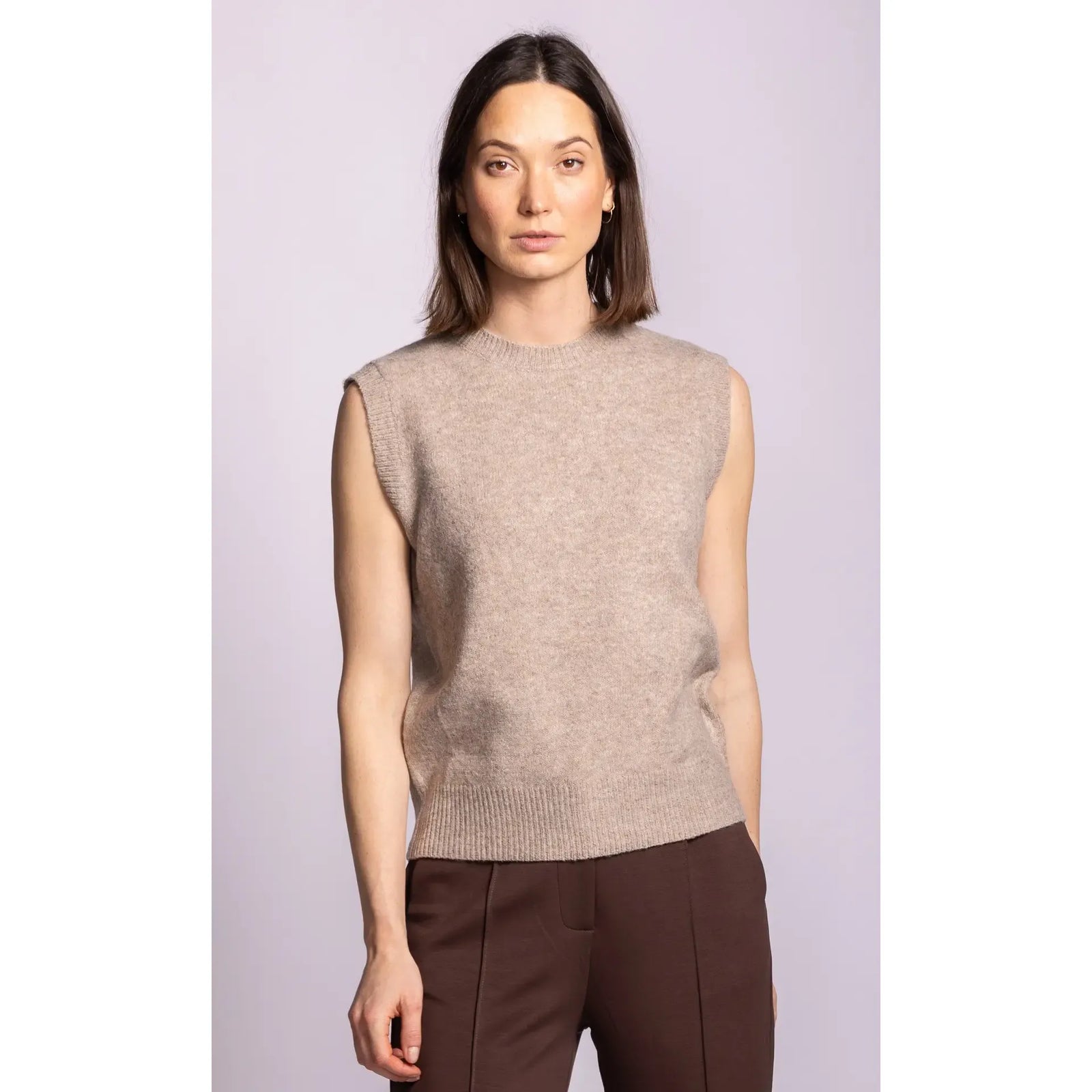 Pink sleeveless ribbed sweater with structured shoulders and hem. A soft, elegant layering piece featuring a refined silhouette.