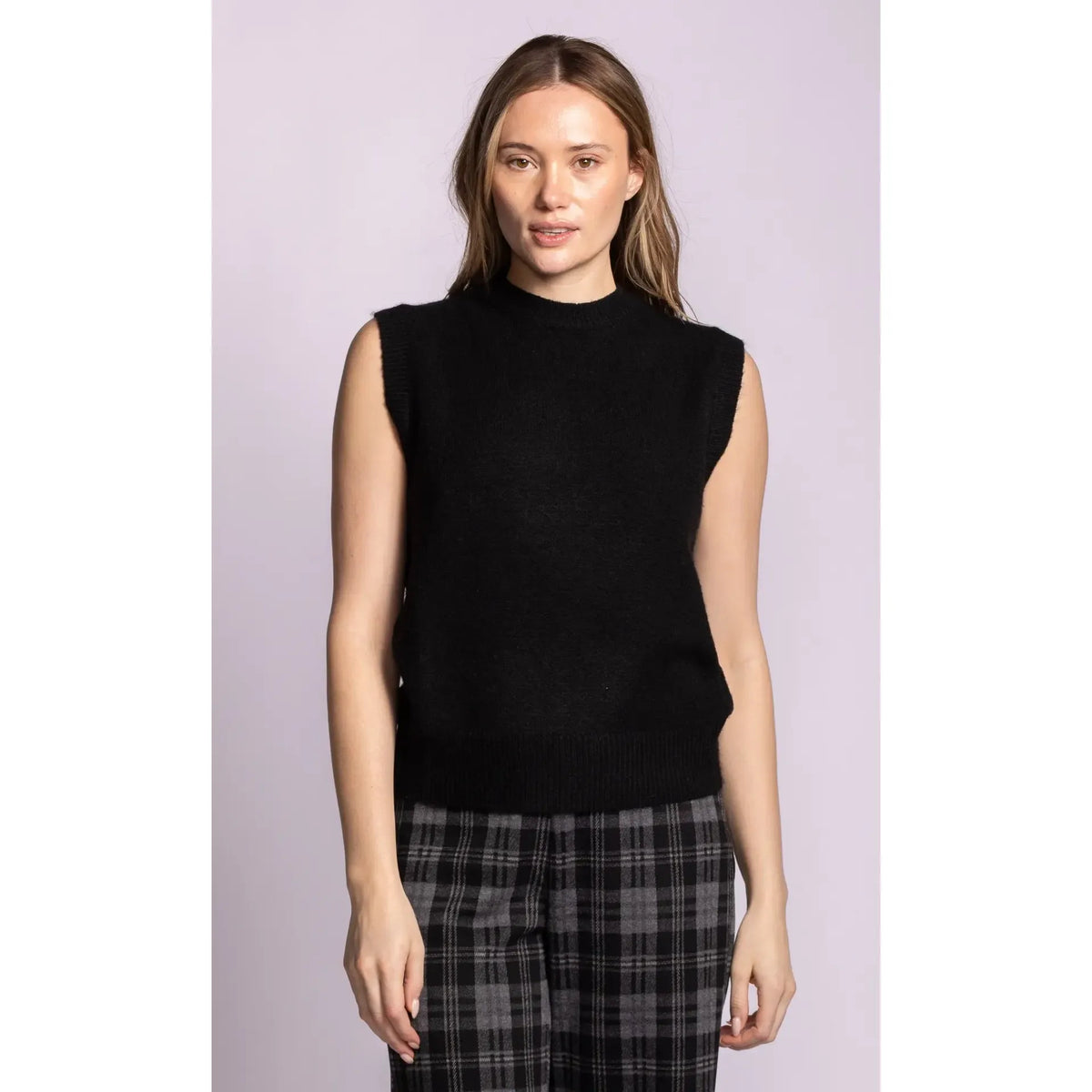Black sleeveless ribbed sweater with structured shoulders and hem. Soft knit vest offering a refined silhouette for elegant layering.