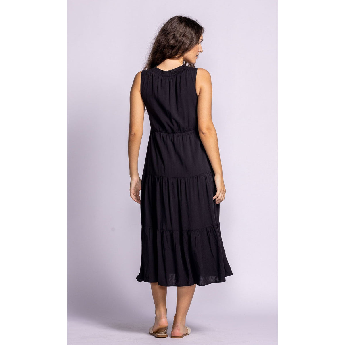 Stylish woman models the Pink Martini Jennifer Dress, showcasing its elegant tiered design and comfortable fit.