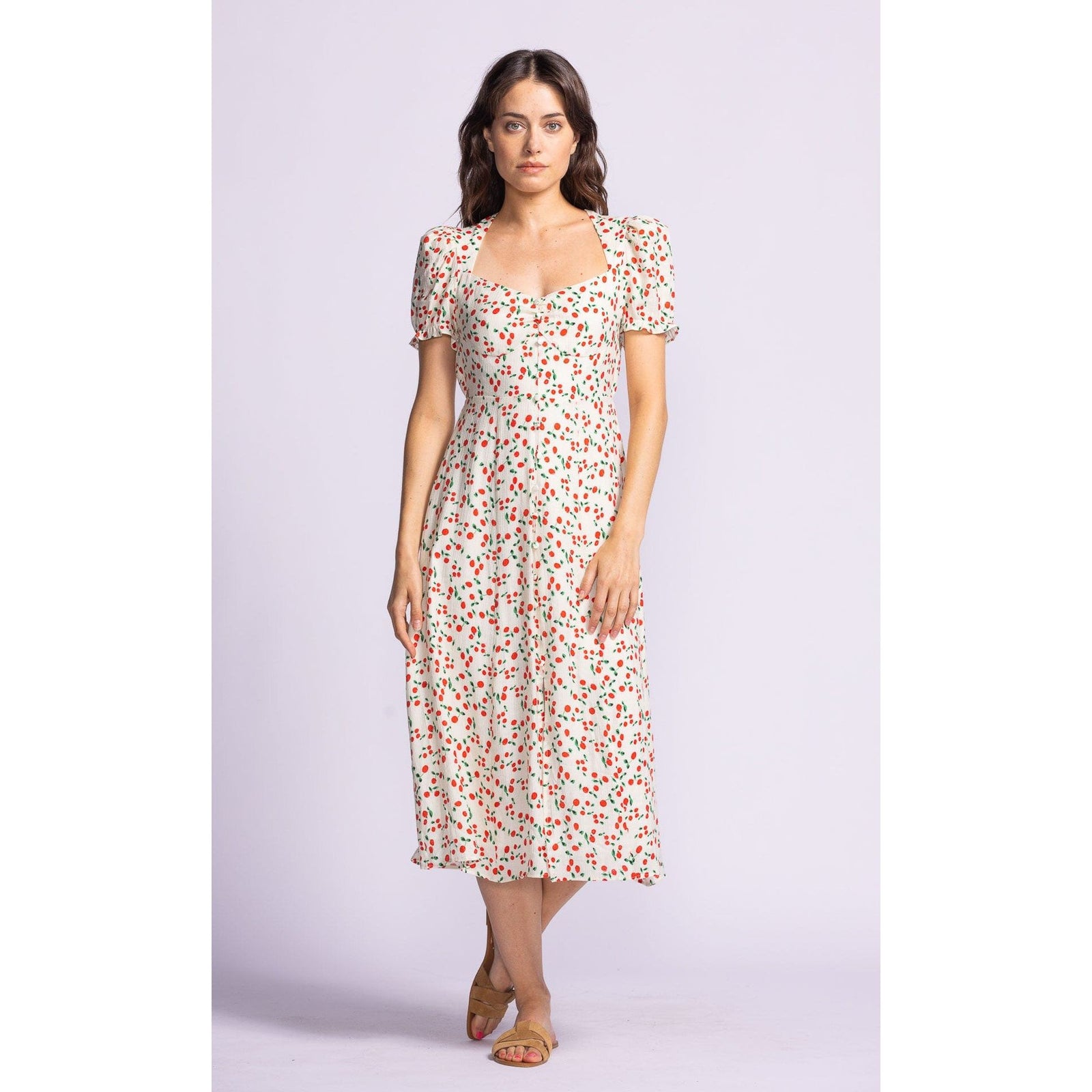 Flirty and fun, the Pink Martini Lala Dress features a sweetheart neckline and puff sleeves for effortless style.