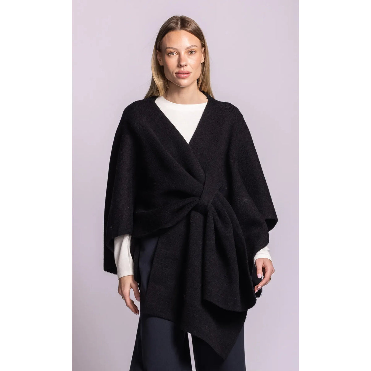 Black Lennon wrap sweater with asymmetric hem and waist tie, combining cardigan ease with poncho silhouette.