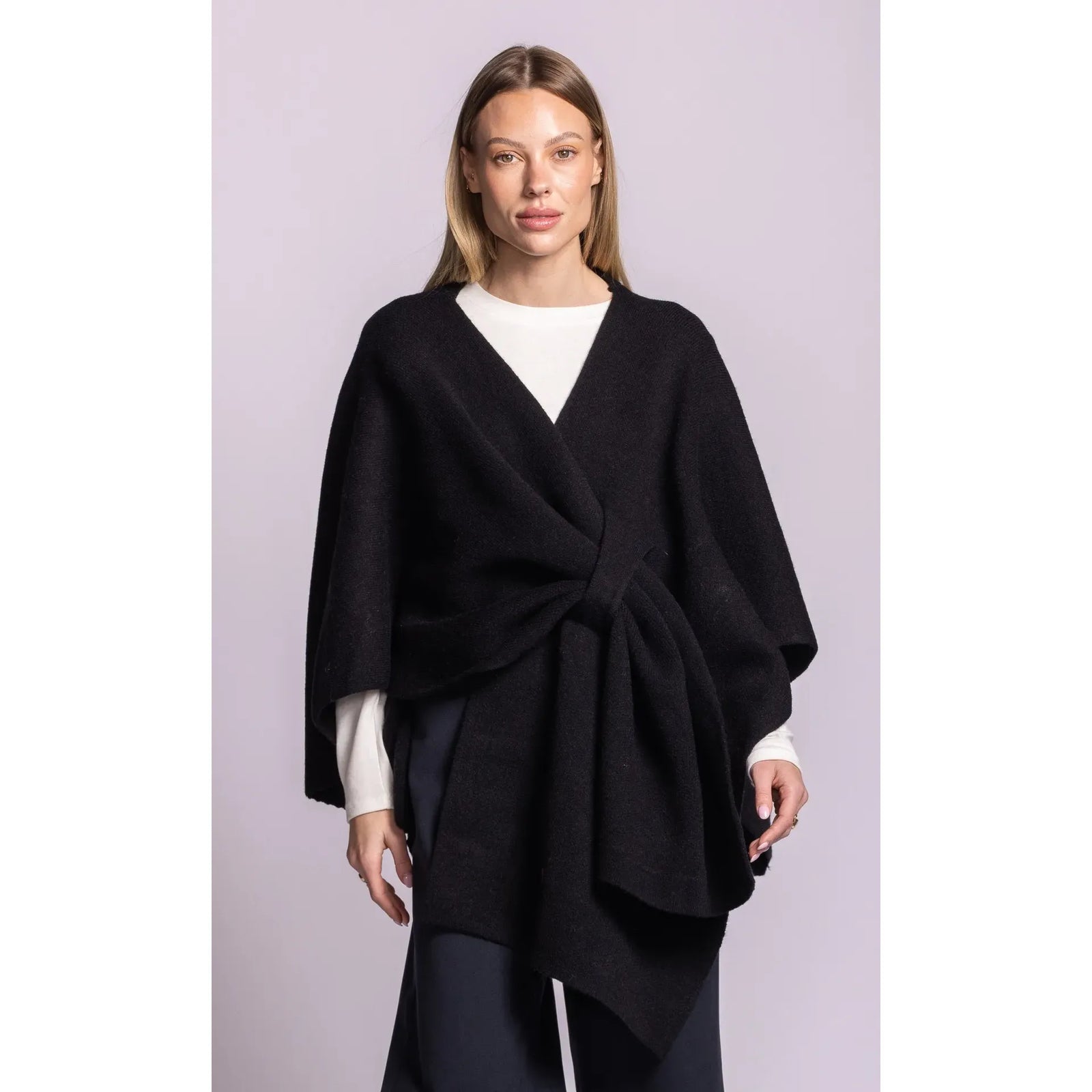 Black Lennon wrap sweater with asymmetric hem and waist tie, combining cardigan ease with poncho silhouette.
