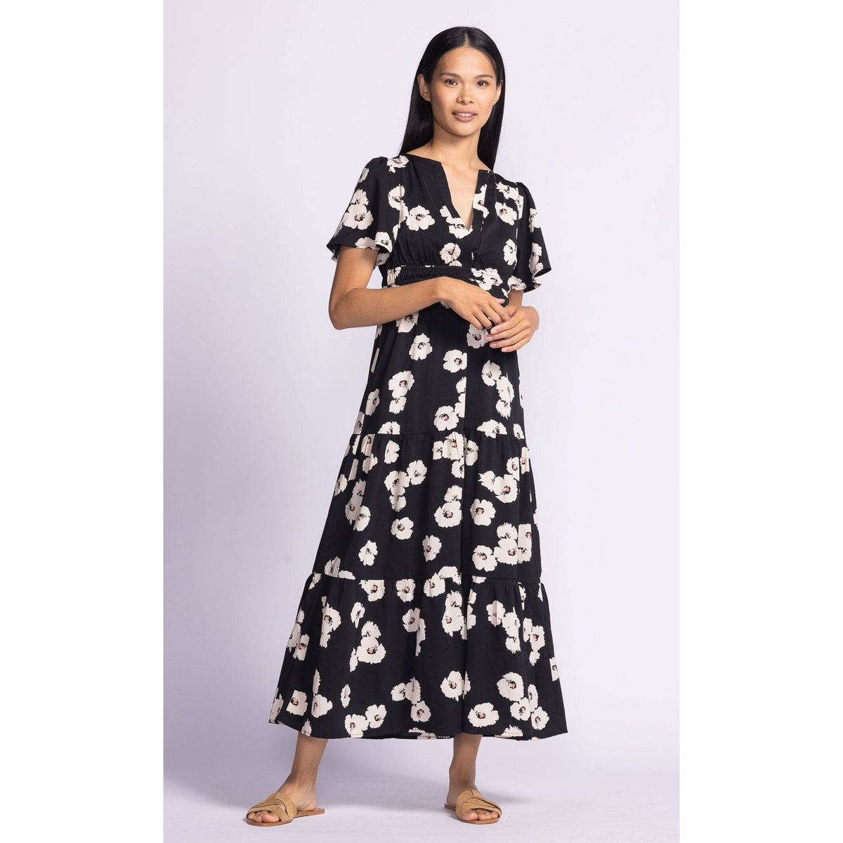 Stylish woman wearing the Pink Martini Margaret Dress with puffed sleeves and floral print, perfect for any occasion.