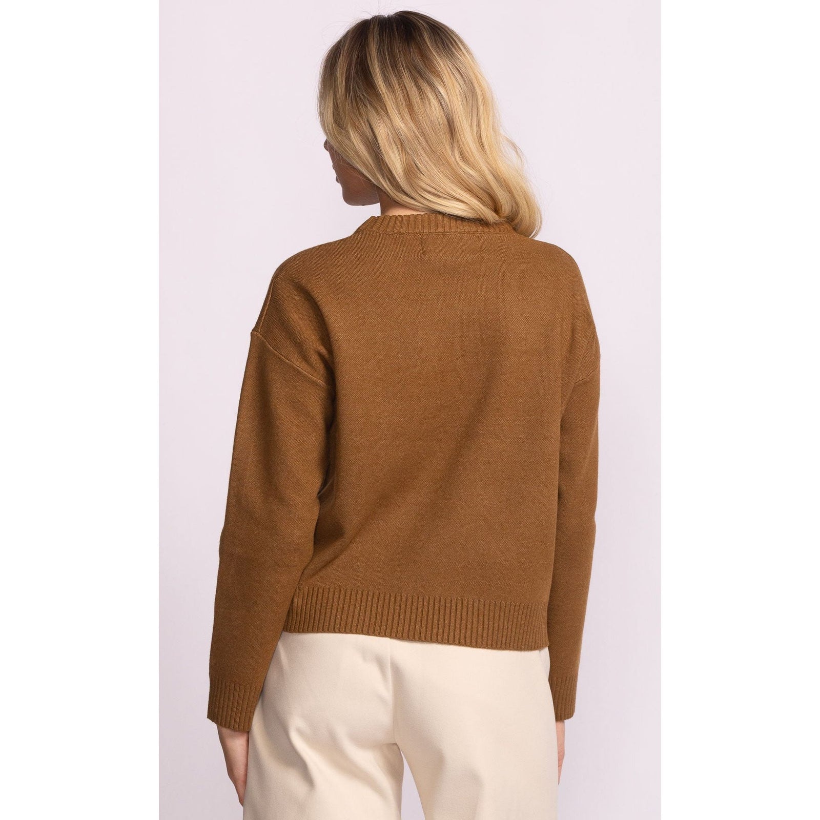 Pink Martini Meadow Sweater in camel brown on model, back view, ribbed hem.
