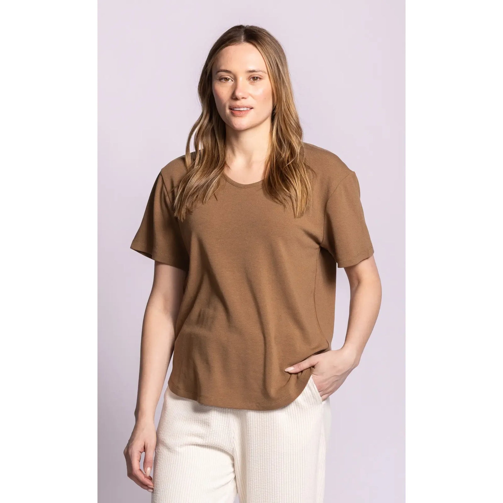 Brown relaxed fit scoop neck top with dropped shoulders and brushed lining, styled with white pants.