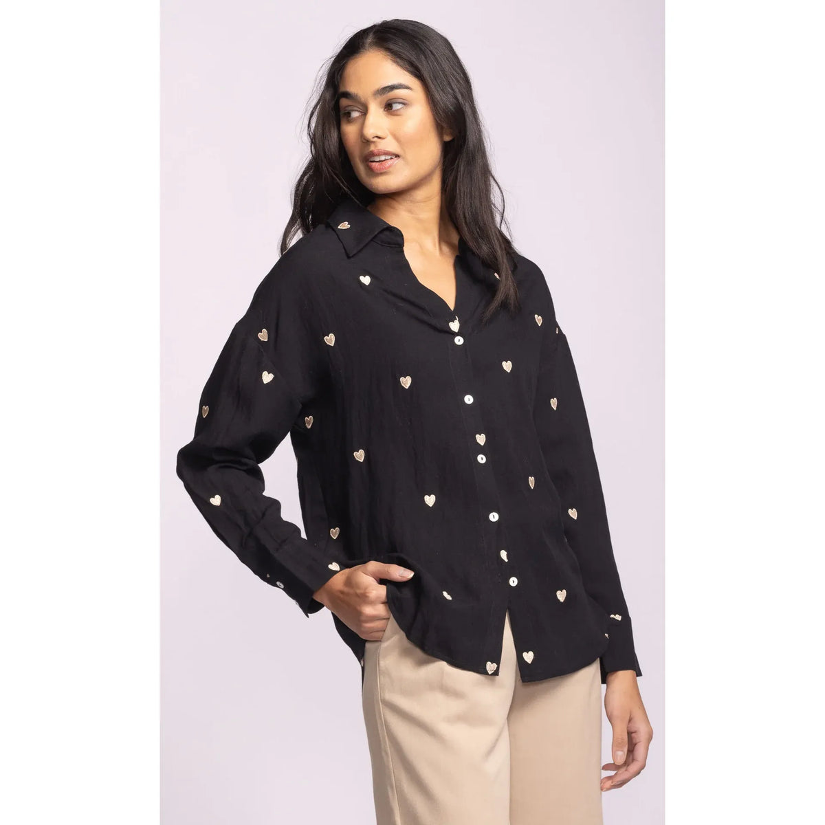 Pink Martini Spezia Top: black shirt with small embroidered hearts, classic collar, V-neck, and buttoned cuffs.