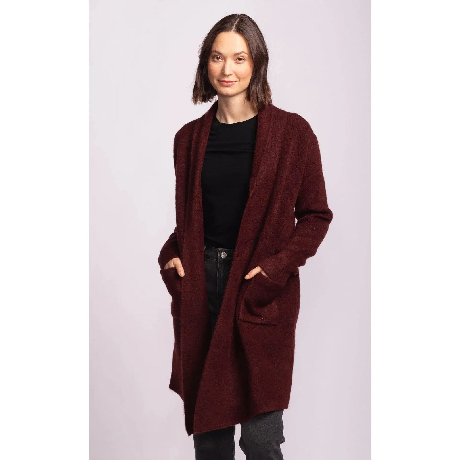 Pink Martini Stockport Jacket in aubergine on model; a burgundy mid-length coat for layering.