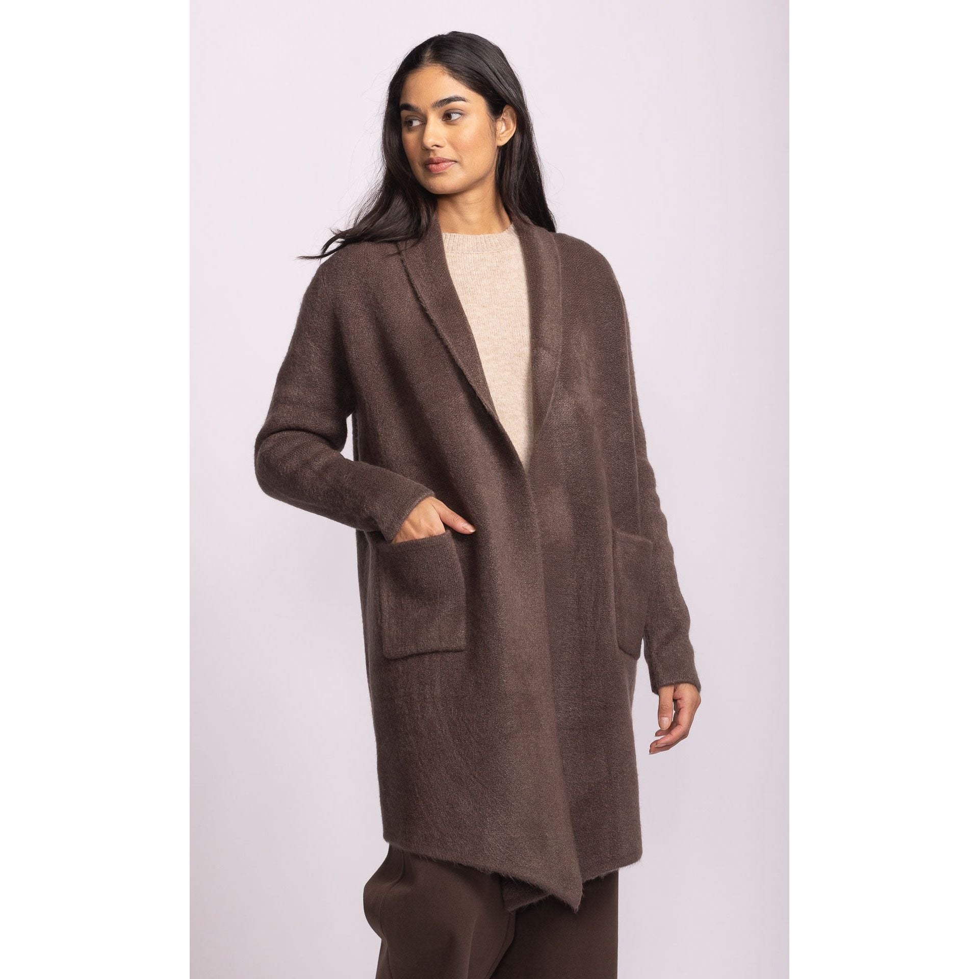 Pink Martini Stockport Jacket: brown mid-length knit coat with front pockets, worn by a model.