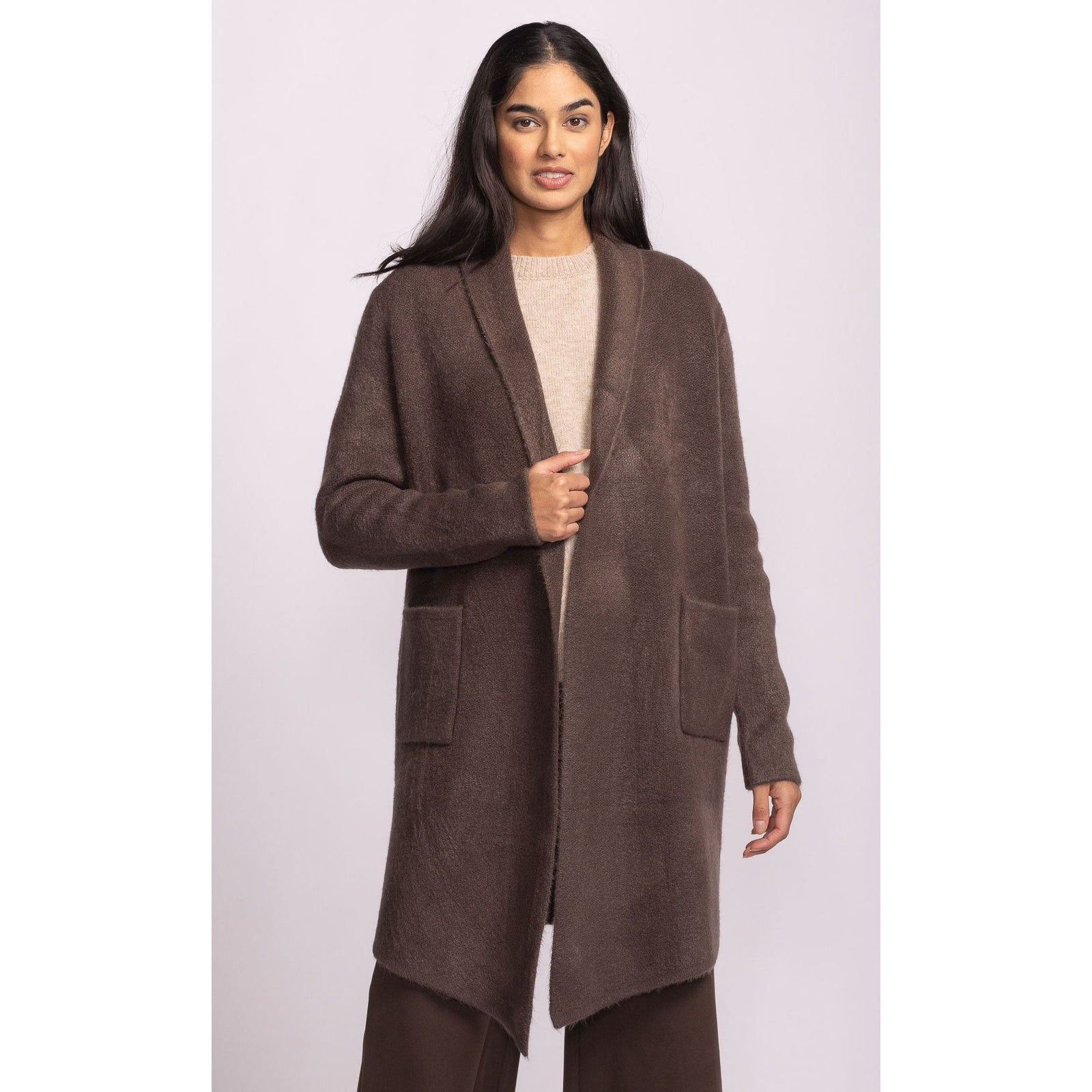 Pink Martini Stockport Jacket in brown knit, mid-length coat with large pockets worn by a model.