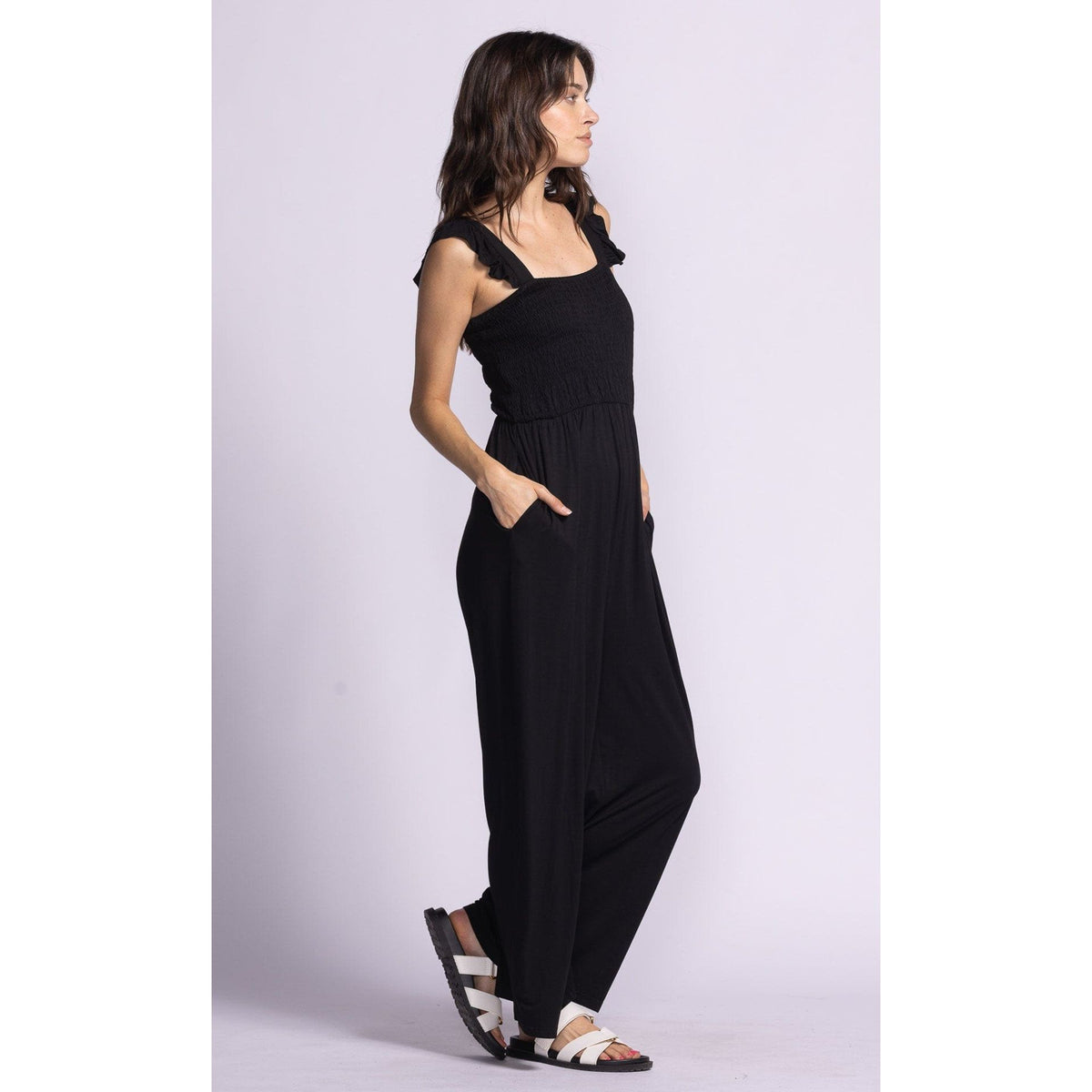 Stylish side view of the Pink Martini Mav Jumper, featuring a smocked bodice and convenient pockets for casual outings.