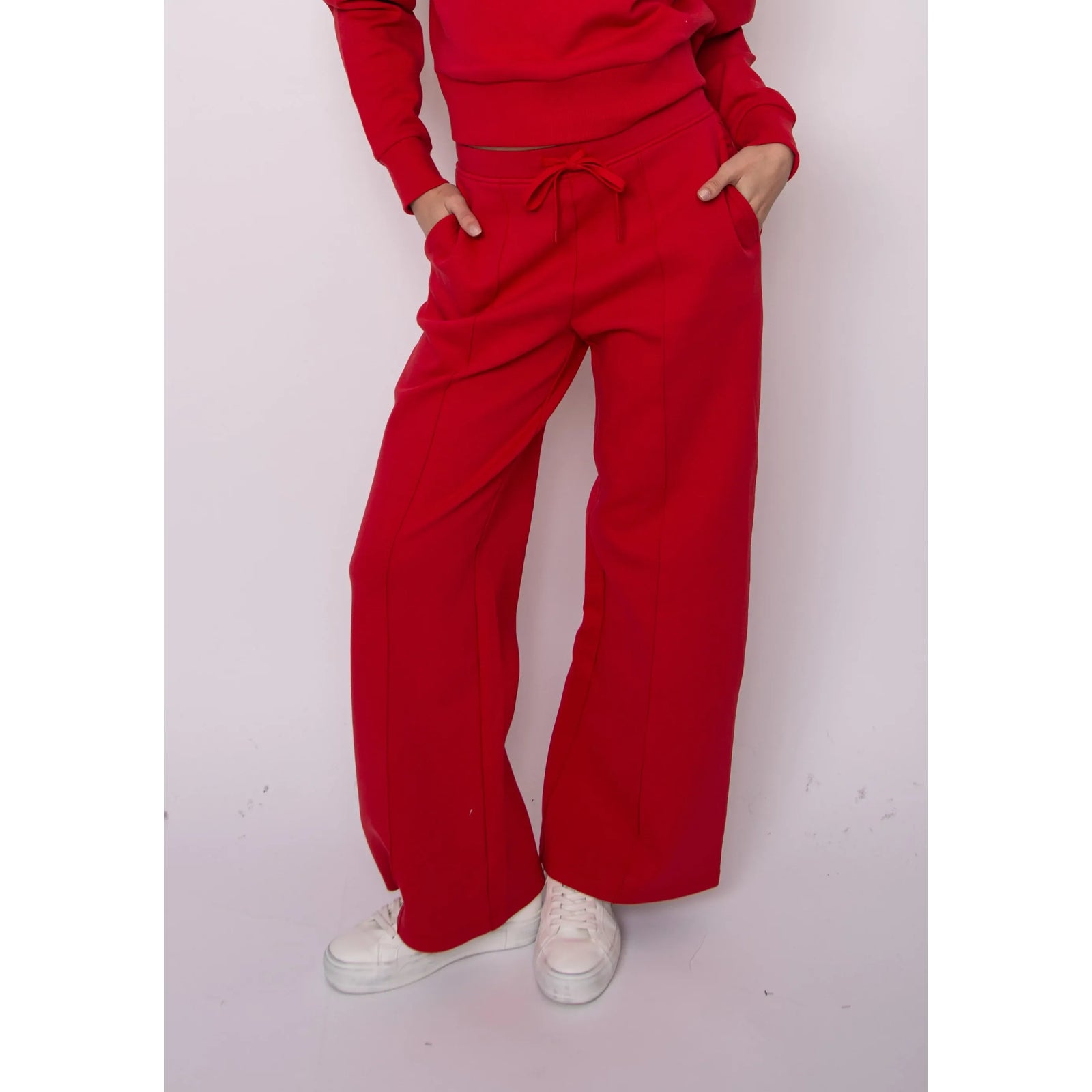Prida Soft Knit Pull-On Drawstring Pant in red with adjustable waist, styled with white sneakers.