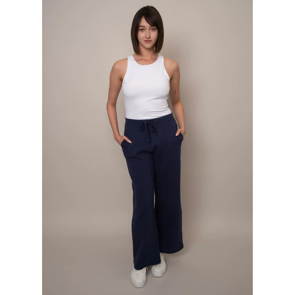Model wearing navy Prida Soft Knit Pull-On Drawstring Pant with white sleeveless top.