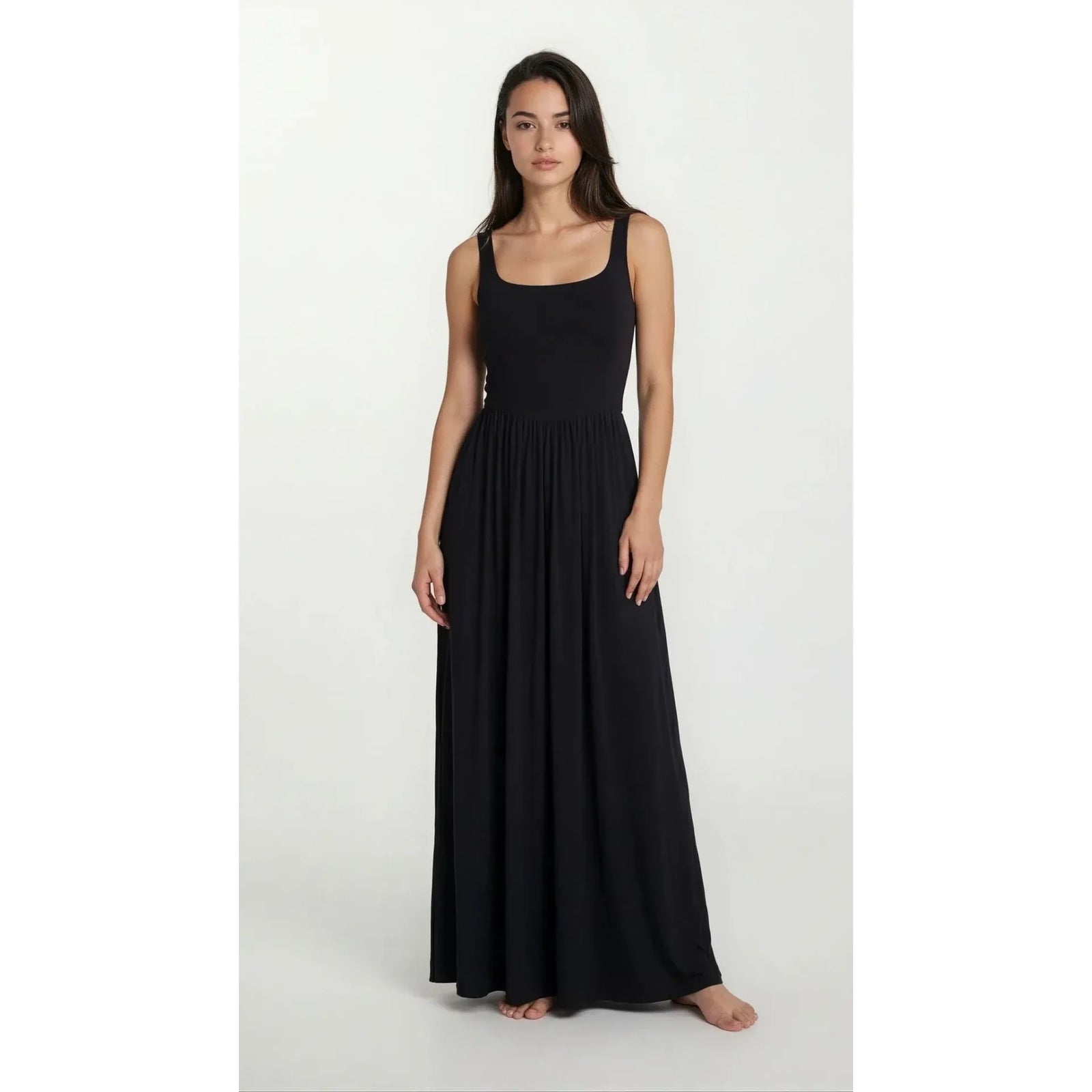 Priv Dawn Maxi Dress in black silky jersey, sleeveless, full-length gown flowing gracefully on a model.