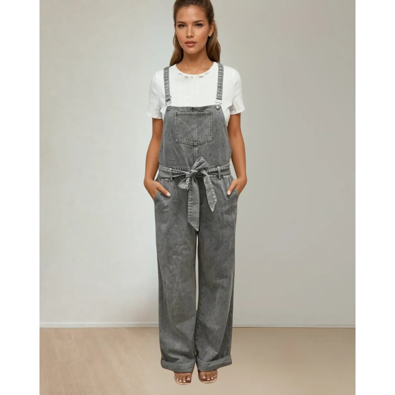 Priv Della Denim Overalls in faded grey, wide-leg silhouette with a bow belt, worn by a model in a white tee.