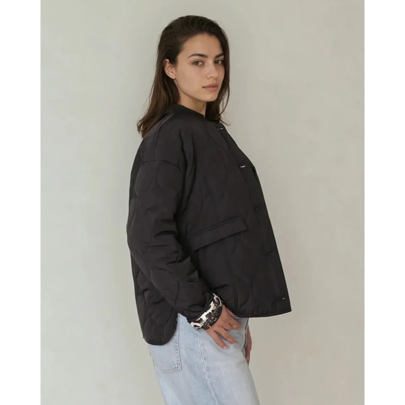 Model wearing Priv Elora Quilted Coat in black with hidden leopard lining and lightweight warmth.