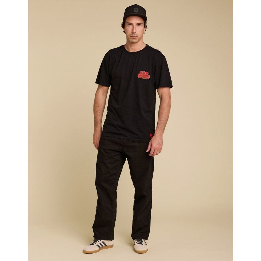 Stylish model wearing the Pullin RelaxBad Tee in black cotton, featuring a ribbed crew neck and short sleeves.