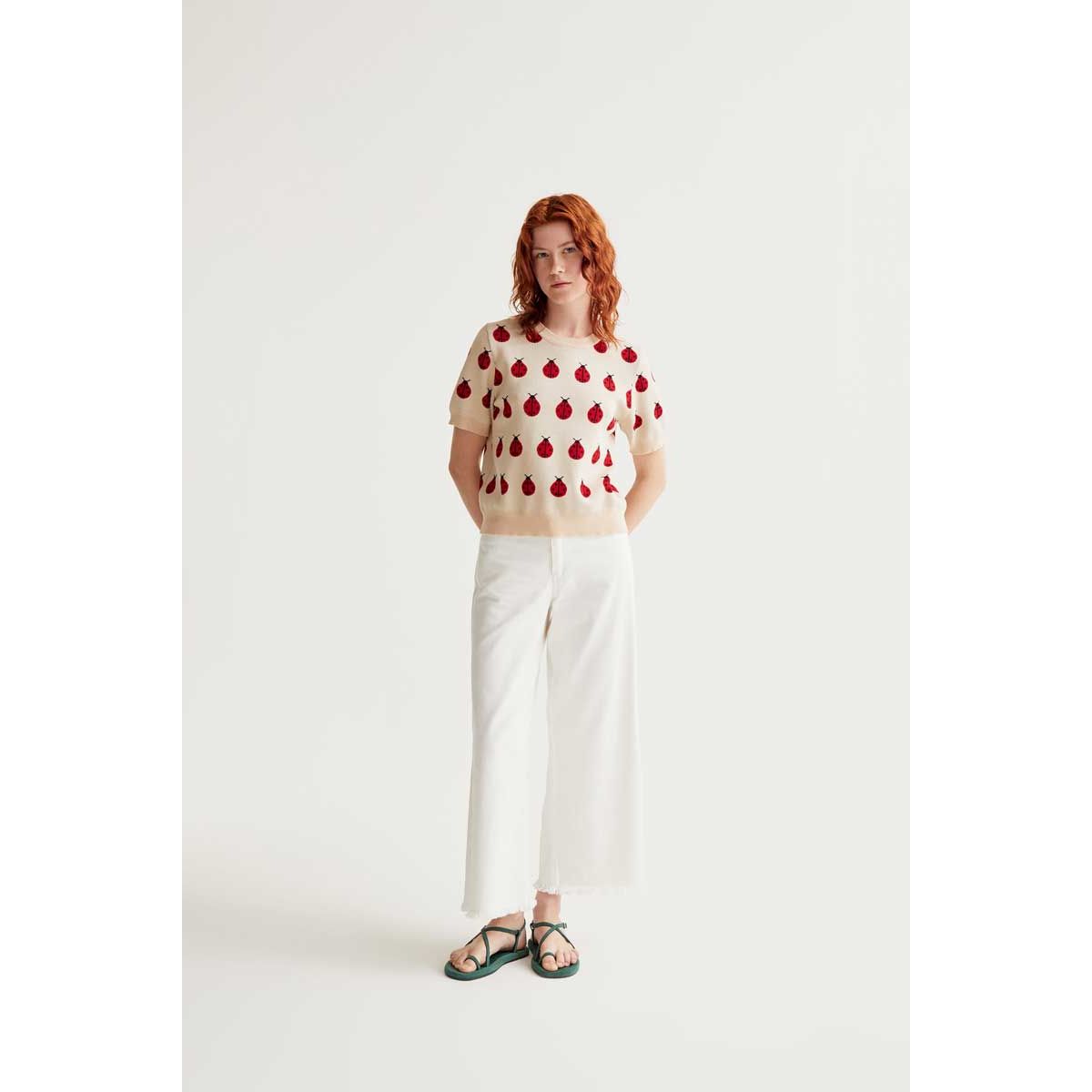 Red Coccinelle Print Tee: cream knit with red ladybug motif, short puff sleeves, round neck, rib-trimmed hem.