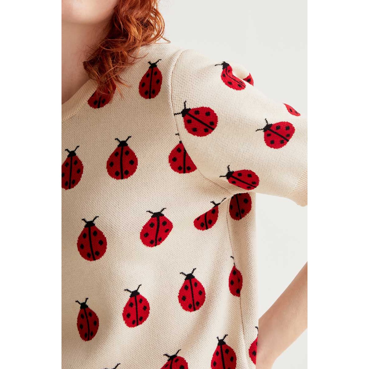 Red Coccinelle Print Tee in cream knit with scattered red ladybug motifs.