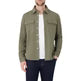 Olive green twill overshirt with buttoned chest pockets and pointed collar, worn open over a white tee for structured casual layering.