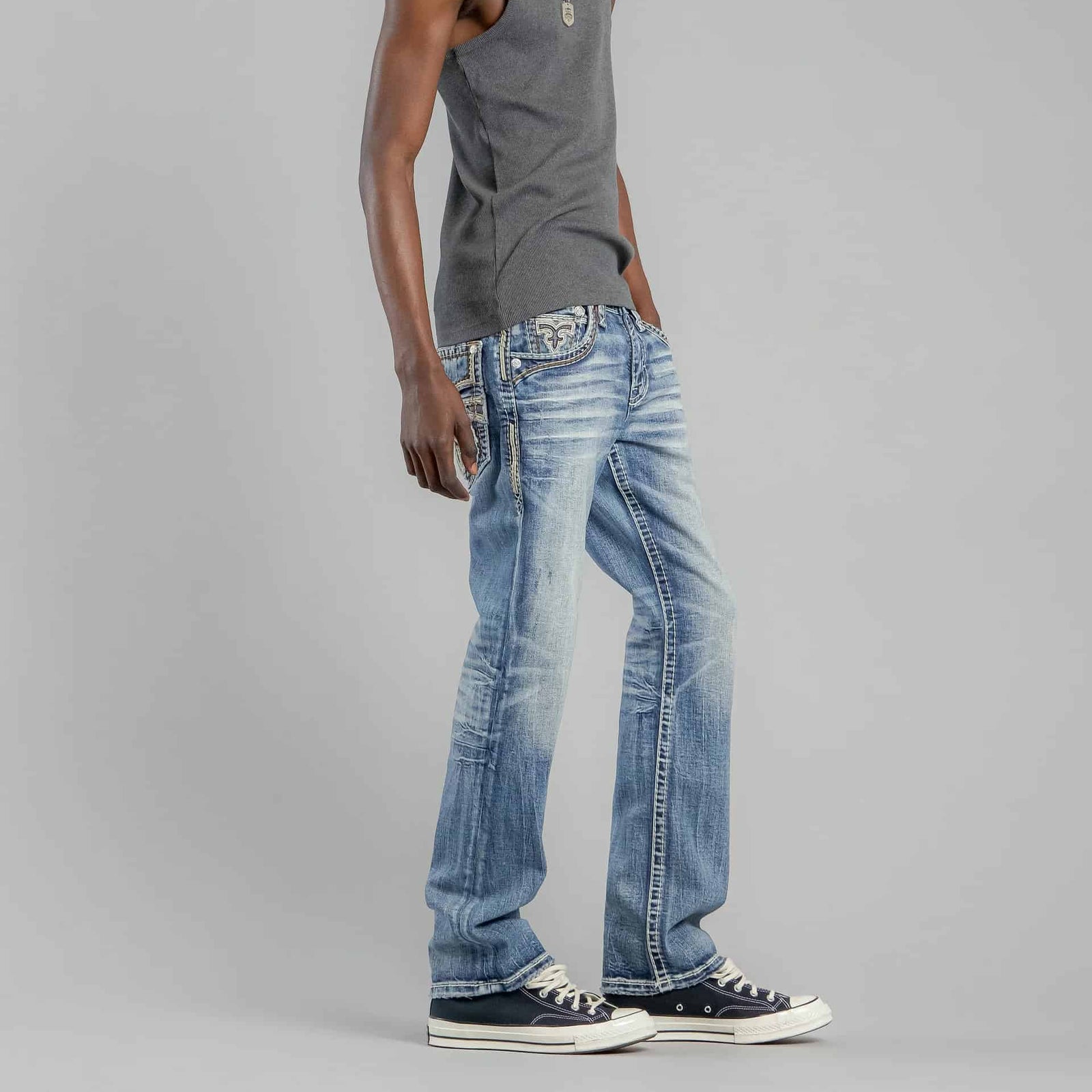 Rock Revival Andrew B200 Bootcut jeans in medium blue wash on a model wearing sneakers.
