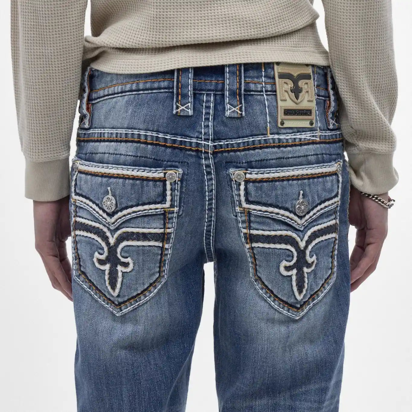 Back view of Rock Revival Caleb J200 straight jeans featuring indigo wash, signature back pocket embroidery, and leather patch.