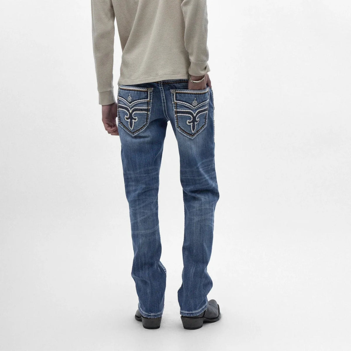 Back view of Rock Revival Caleb J200 Straight jeans featuring signature back pocket embroidery and a rich indigo wash with subtle fading.