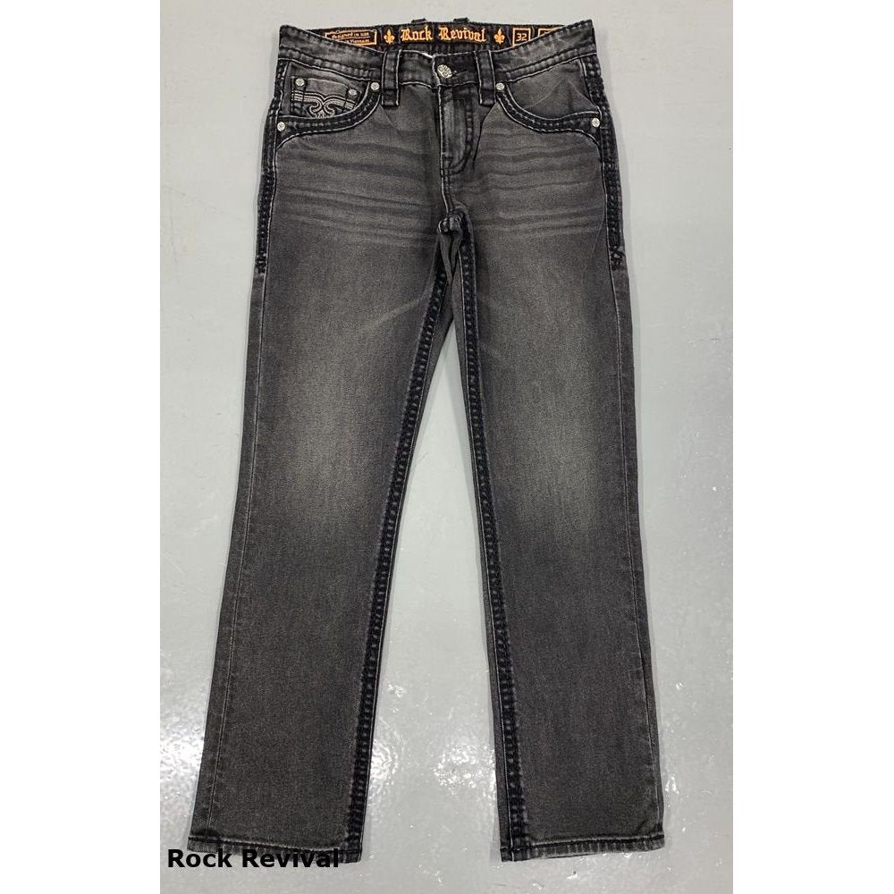 Rock Revival Wes B200 Bootcut jeans in medium indigo with stretch worn by a man in an urban denim shirt and boots.