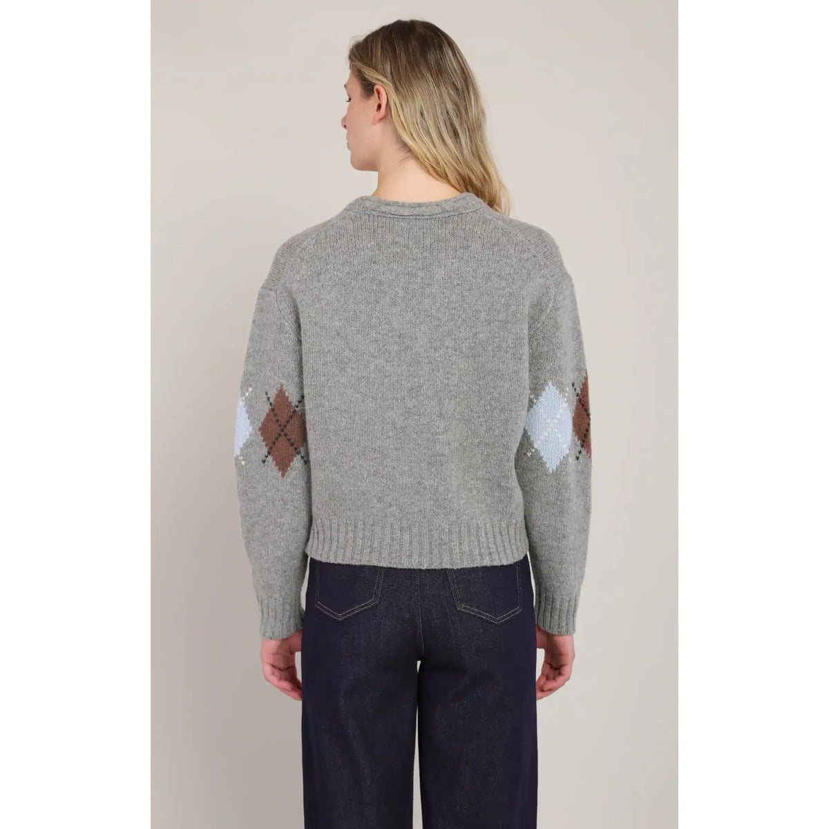 Back view of a grey V-neck argyle sweater featuring diamond patterns in brown and light blue on the sleeves.