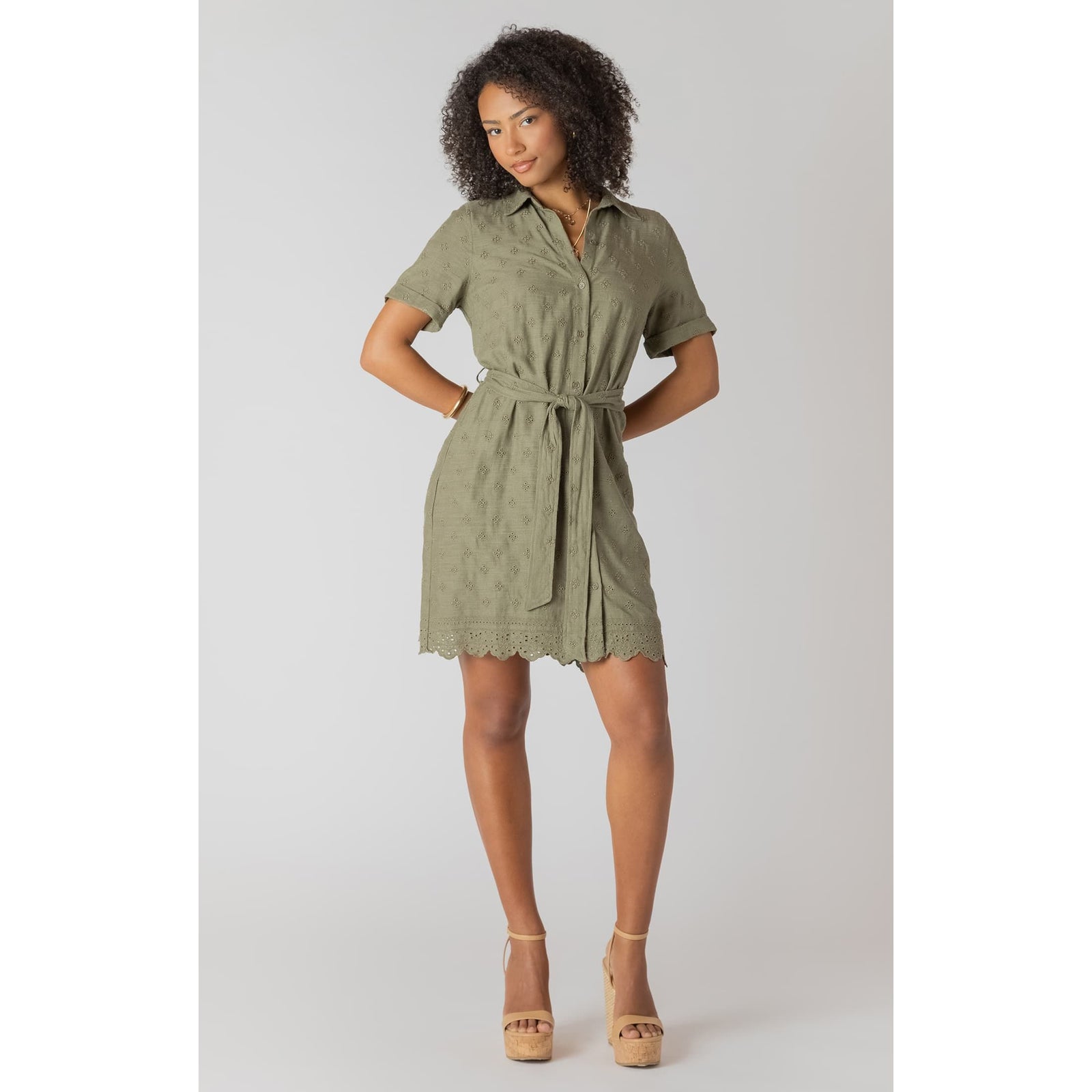Sage linen belted mini shirt dress with eyelet embroidery and scalloped hem, model wearing it.