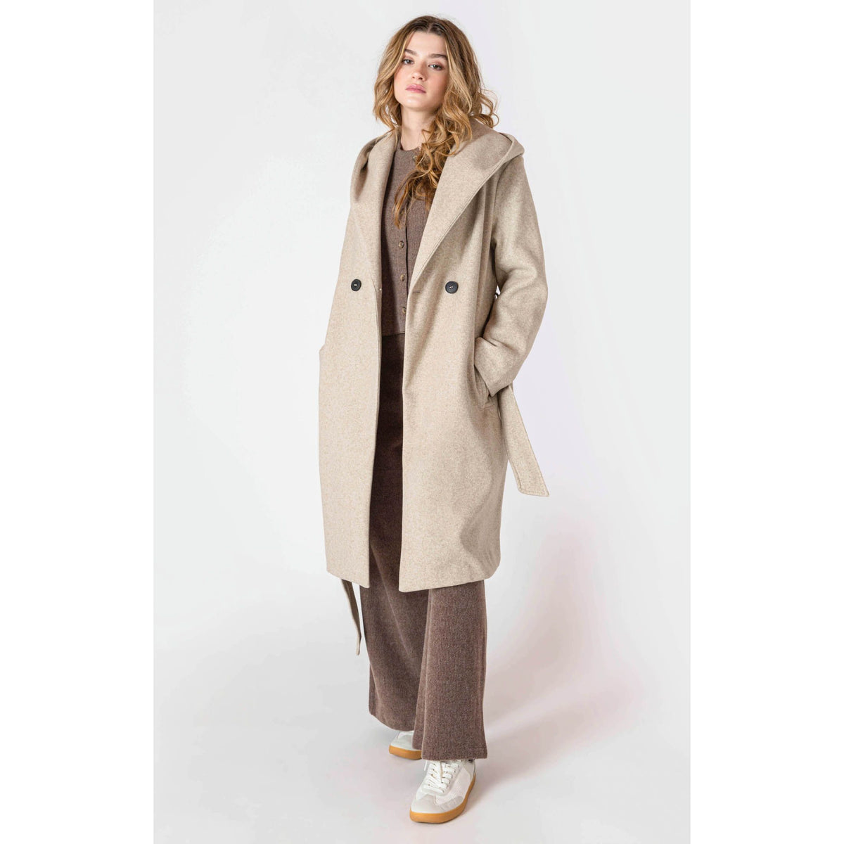 Room 34 Belted Hooded Coat in beige, long belted coat with hood and front buttons worn by a model.