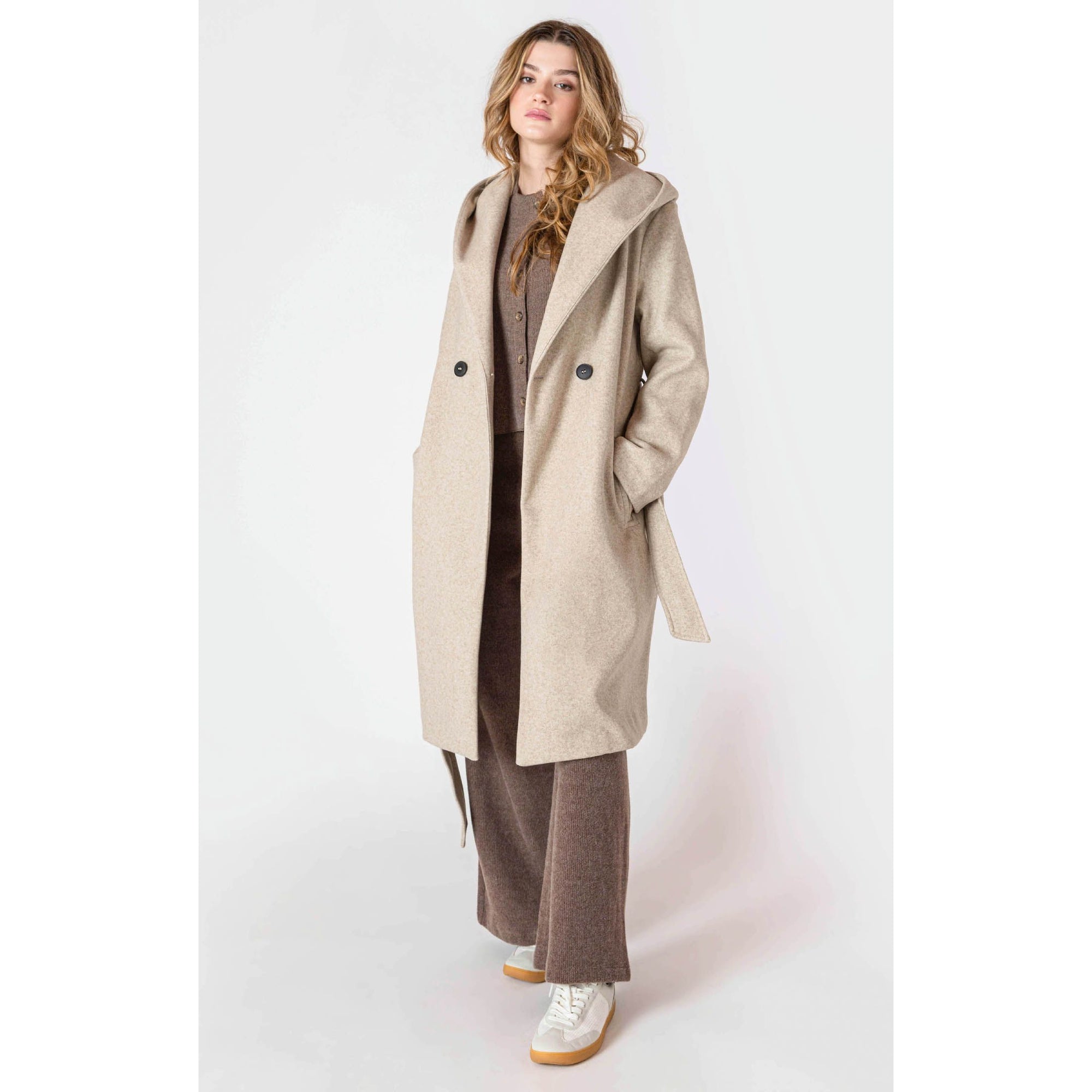 Room 34 Belted Hooded Coat in beige, long belted coat with hood and front buttons worn by a model.