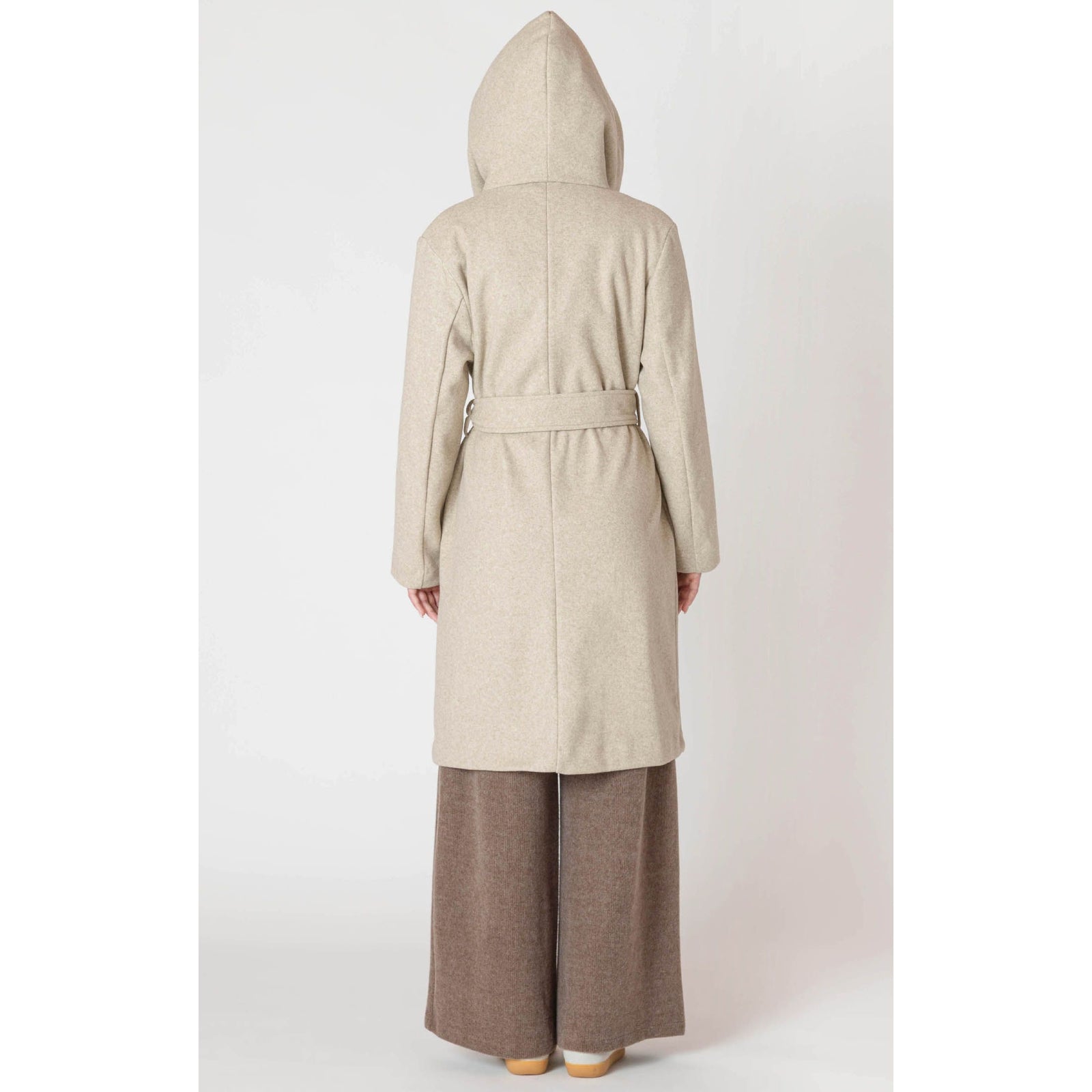 Room 34 Belted Hooded Coat on a model, back view in beige, long belted hooded coat.