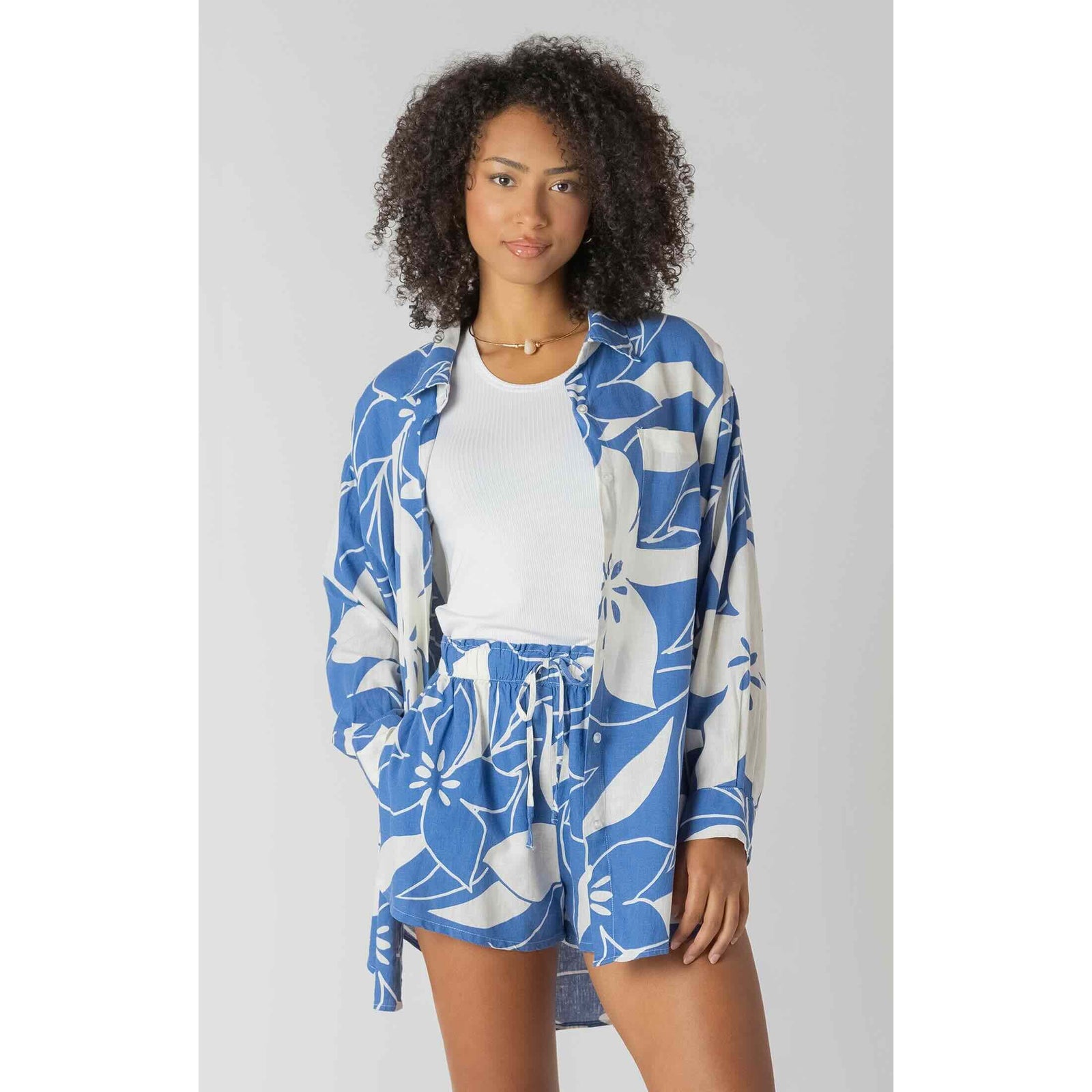 Room 34 Button Front Linen Shirt in blue floral print worn open over a white ribbed tank by model