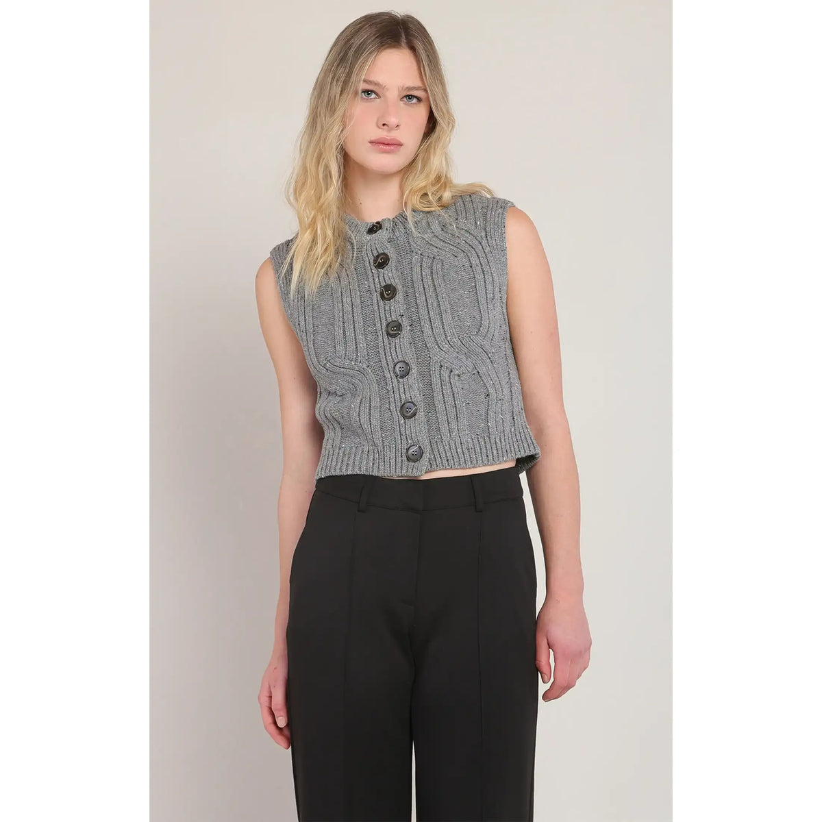 Room 34 gray button-front cable-knit sweater vest, cropped, styled over black high-waisted pants.