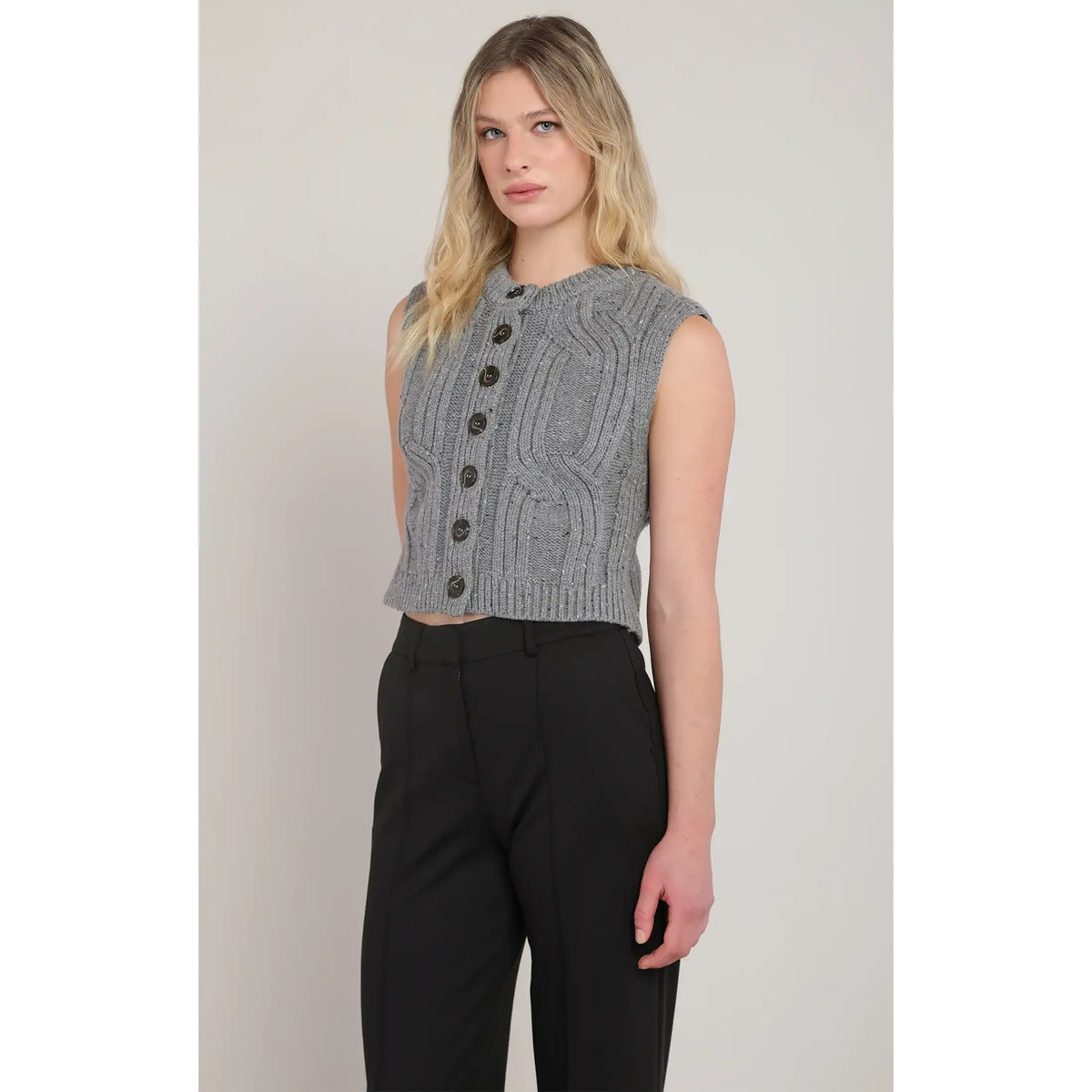 Room 34 Button Front Cable Knit Sweater Vest, gray cropped sleeveless knit with buttons over black pants.