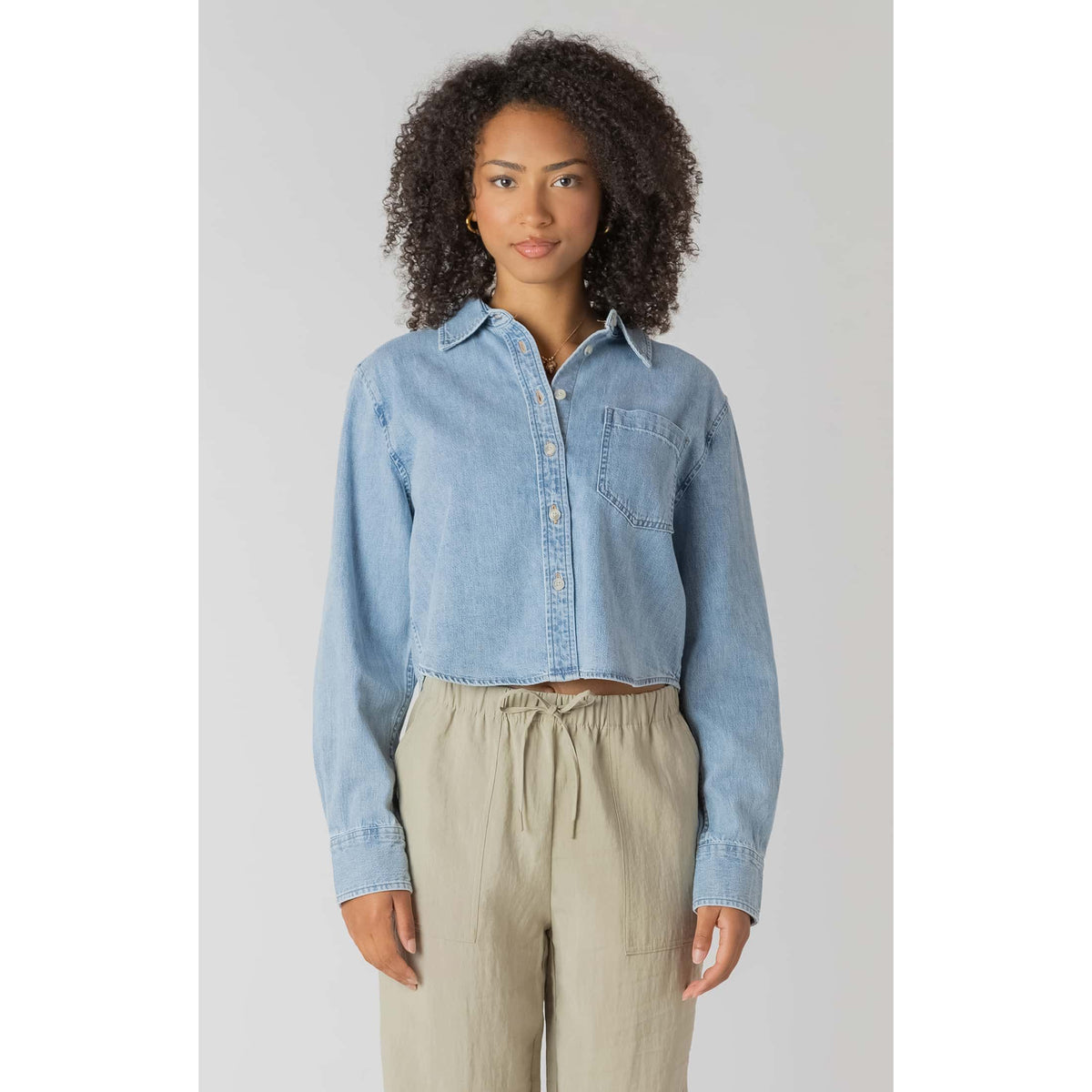 Room 34 lightweight cropped denim shirt with long sleeves and chest pocket, shown on model.