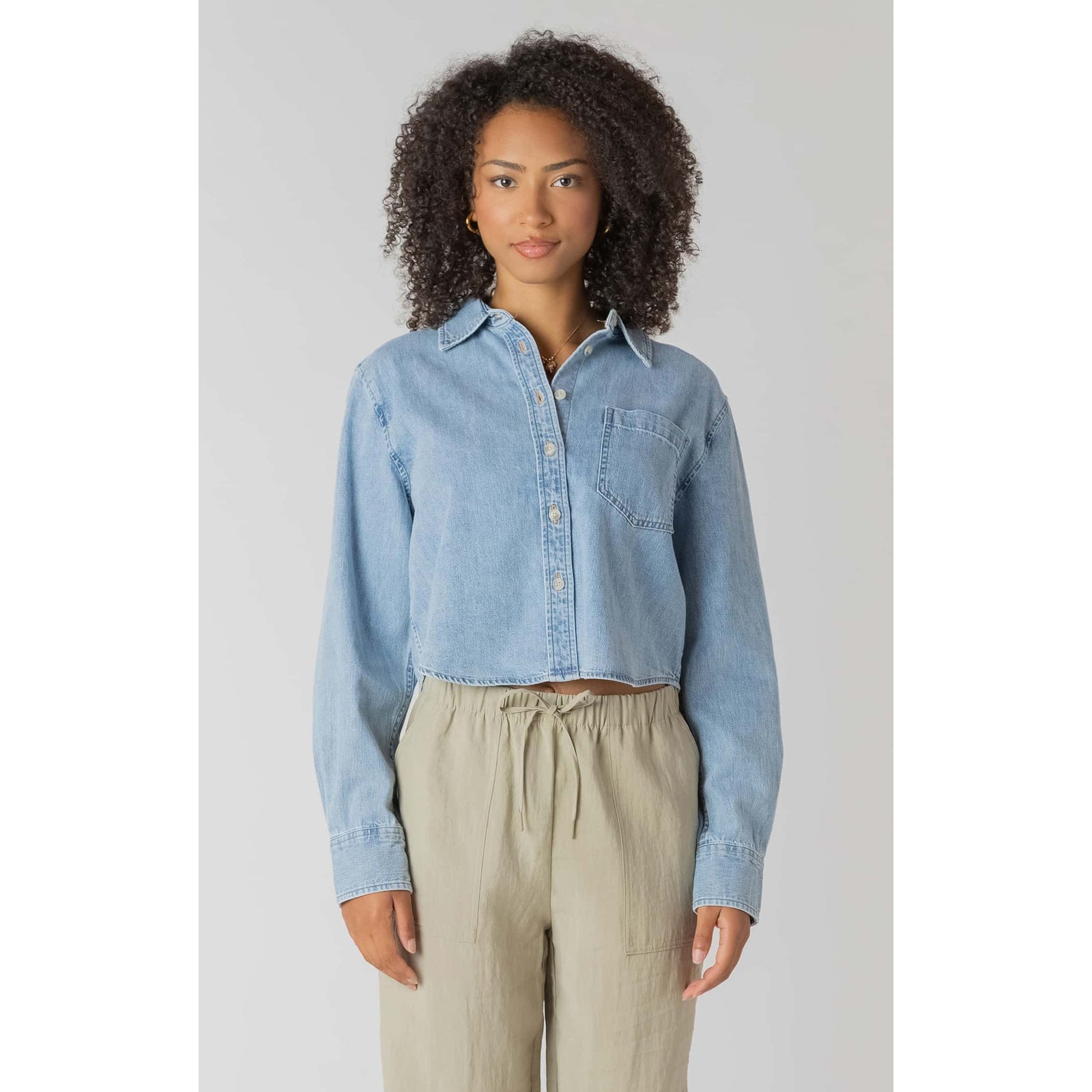 Room 34 lightweight cropped denim shirt with long sleeves and chest pocket, shown on model.