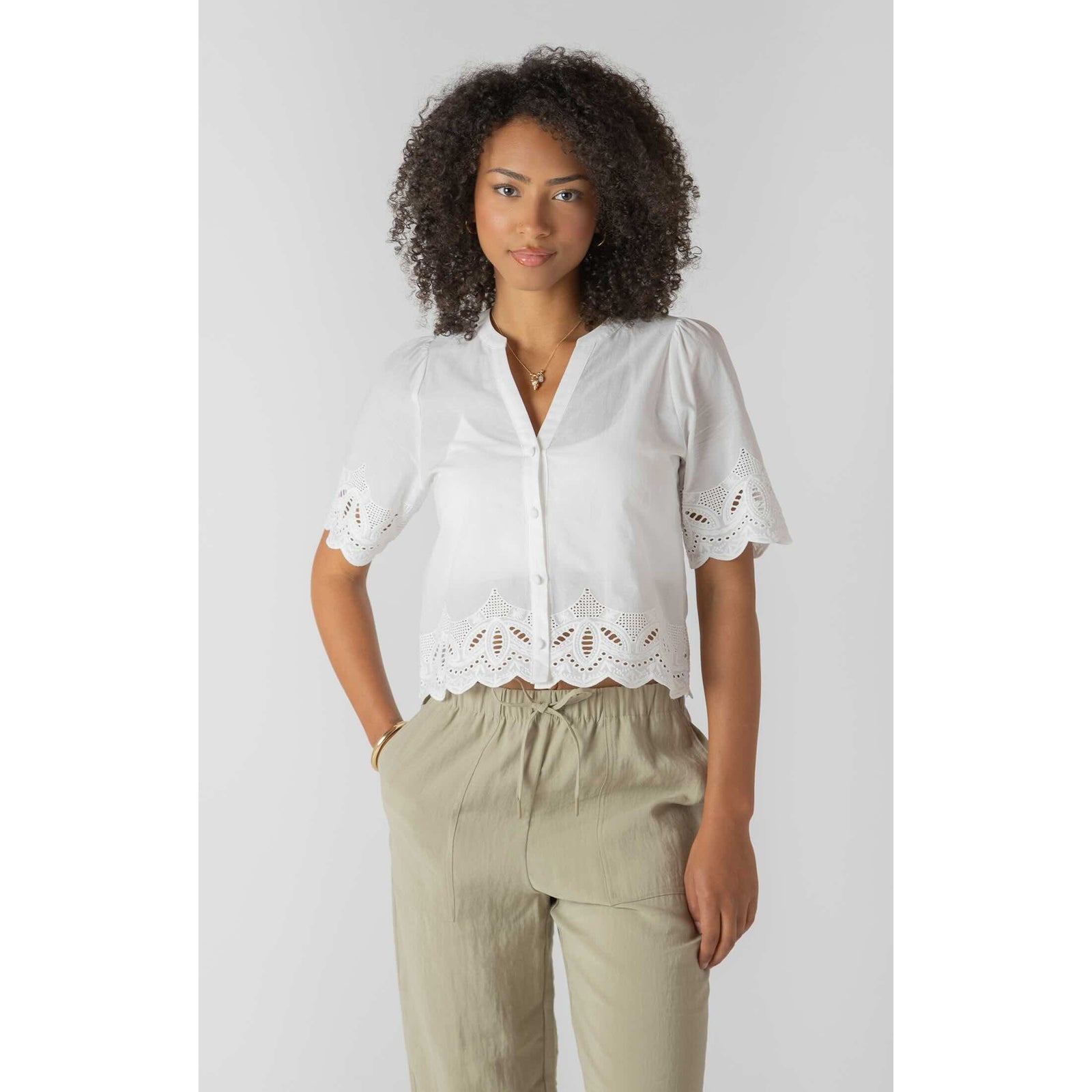 Room 34 Eyelet Trim Blouse in white with scalloped eyelet hem and puff sleeves.