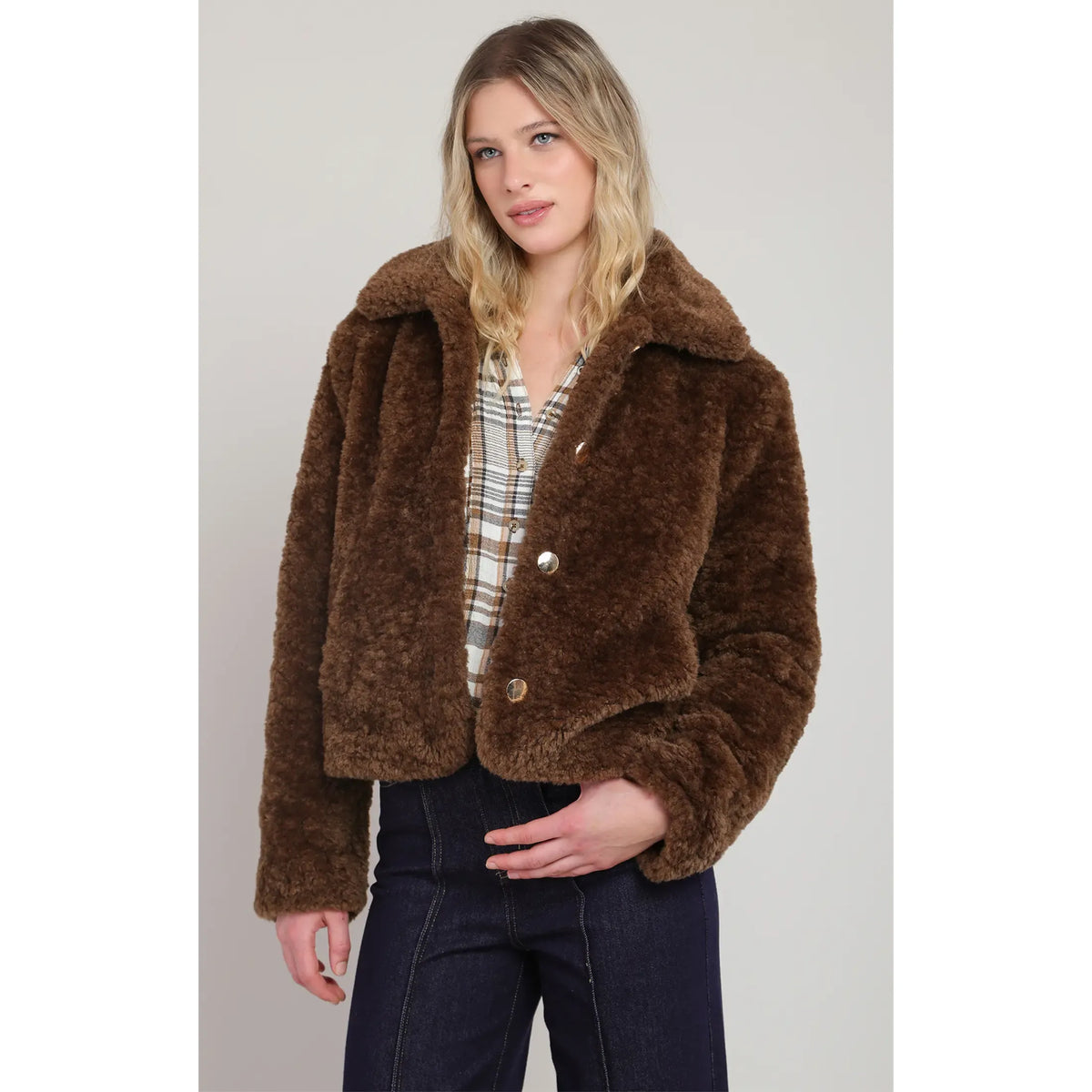 Brown faux fur coat featuring a plush texture, wide collar, gold buttons, and side pockets for cool-weather warmth.