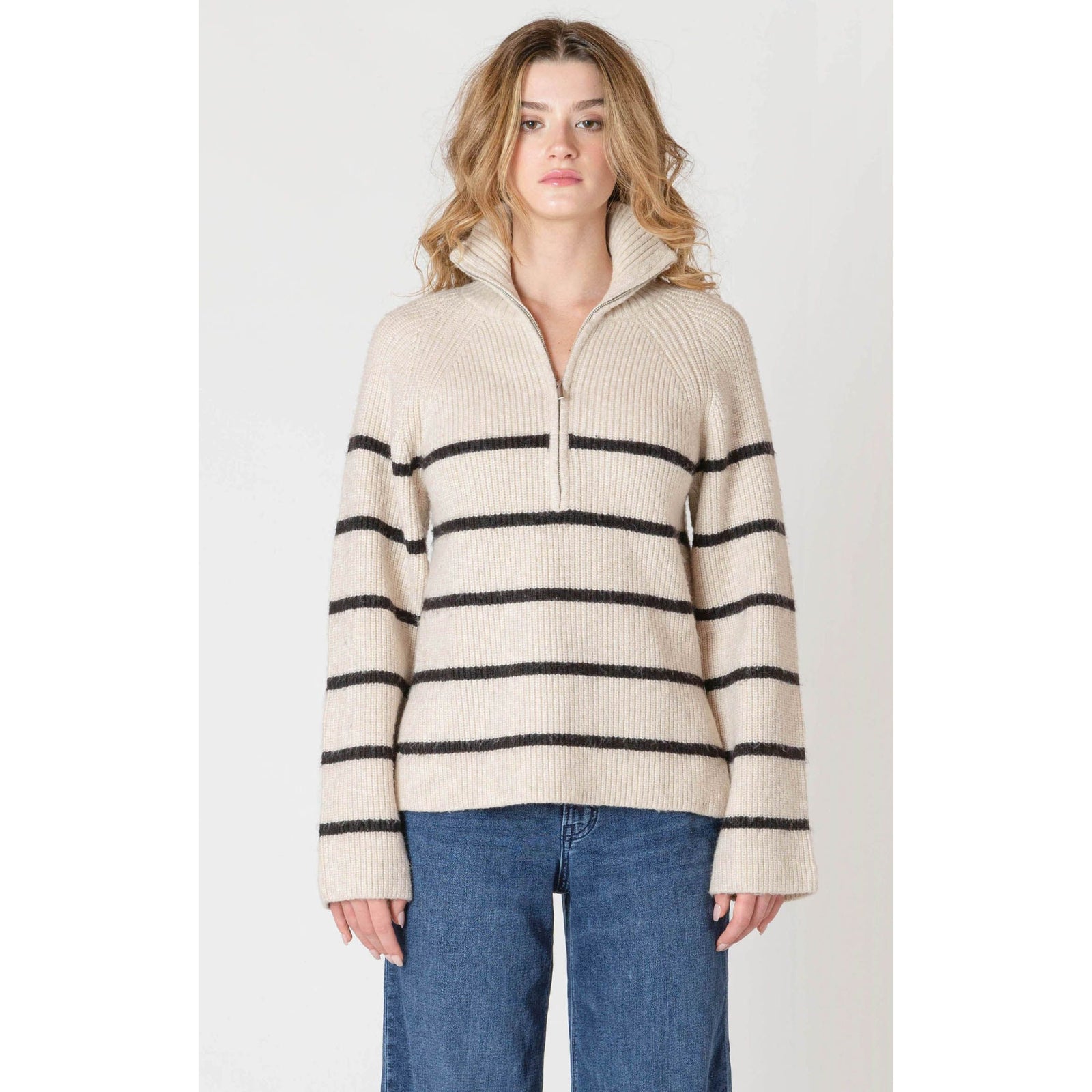 Beige oatmeal Room 34 half-zip longline sweater with bold black stripes on a model.